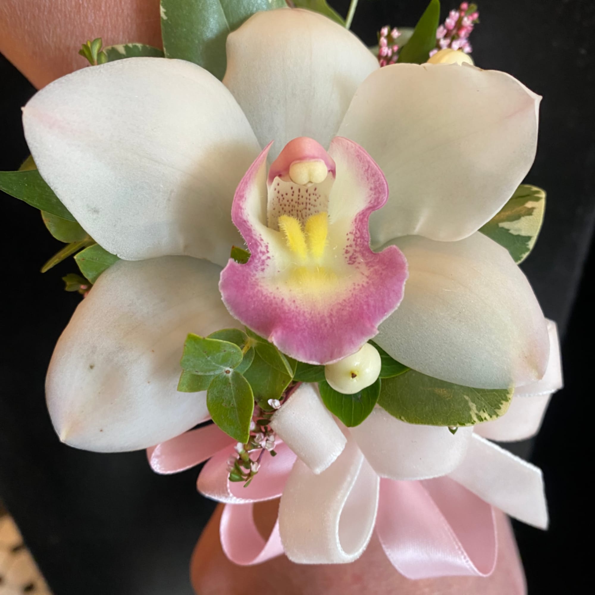 White and pink orchid bouquet with a satin ribbon wrap