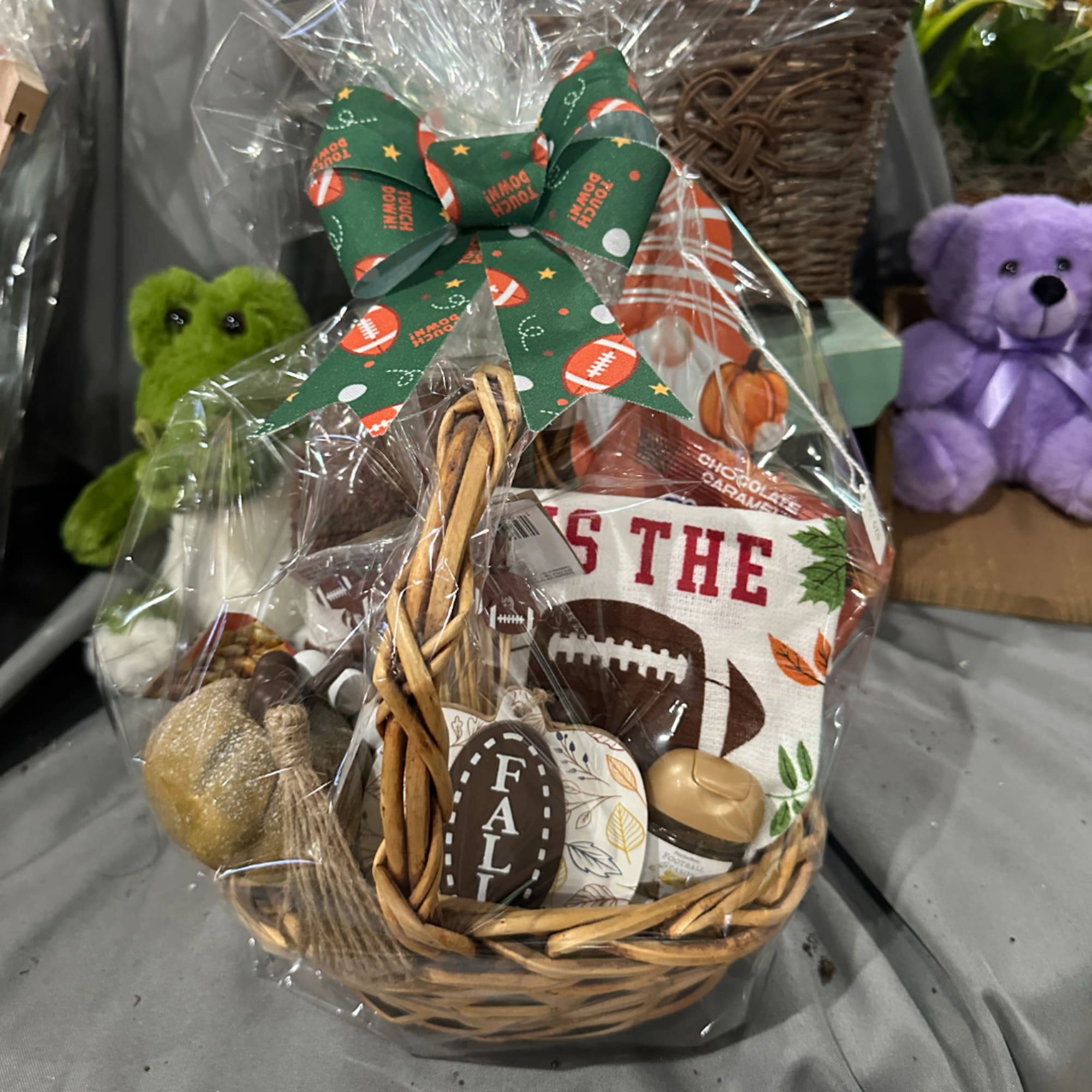 Basket gift set with football decor and a green bow