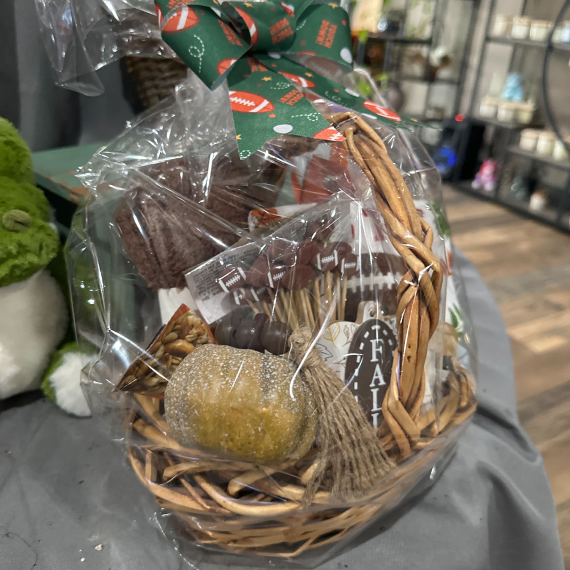 Fall gift basket with a woven handle and decorative pumpkin