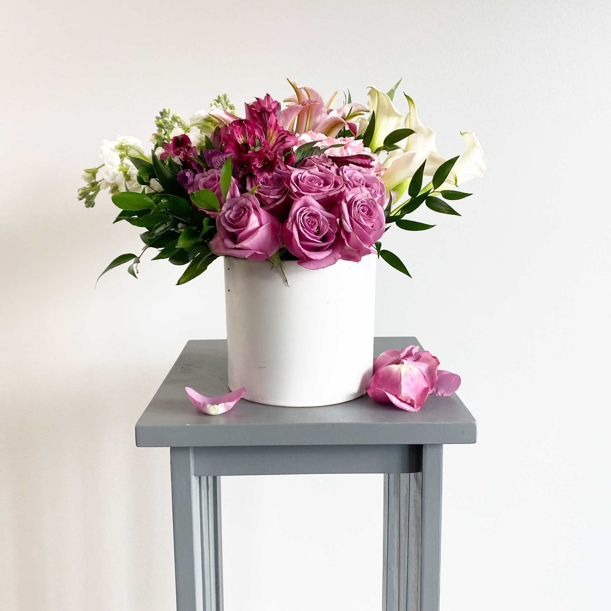 Pink and white flower arrangement in a white vase
