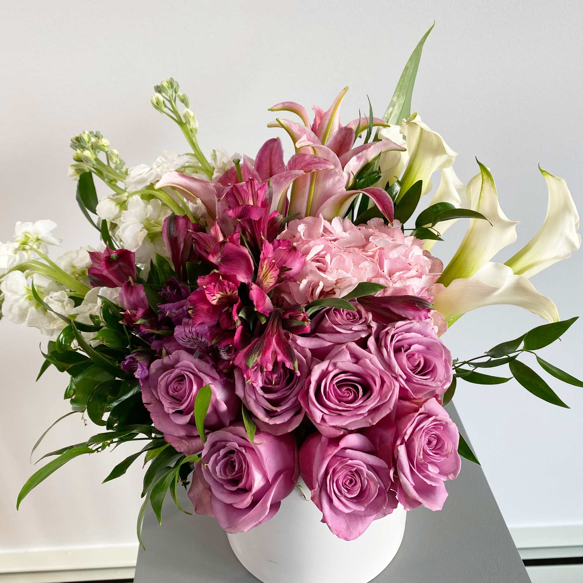 Pink and white bouquet in a white vase