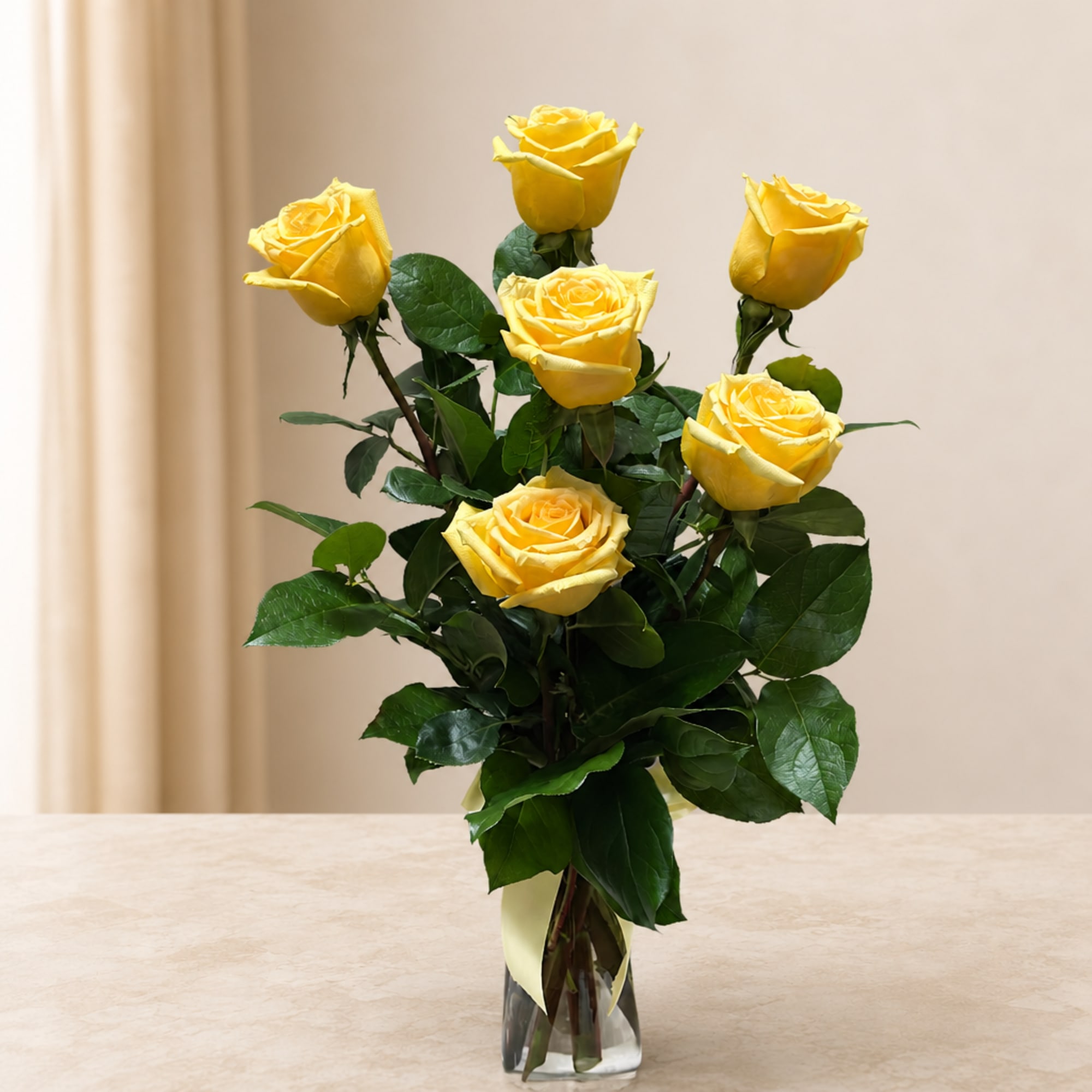 Yellow roses arranged in a clear glass vase