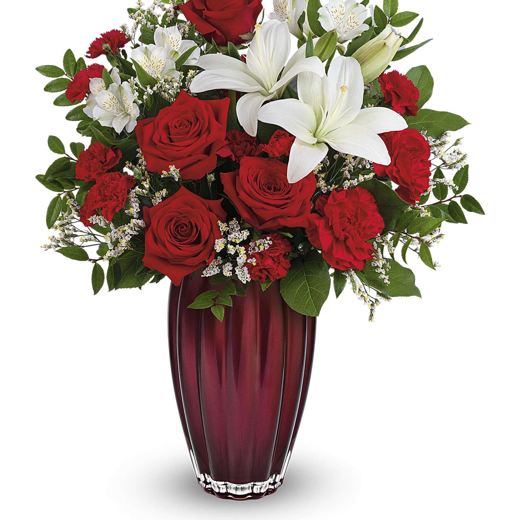Red roses and white lilies arranged in a tall burgundy vase