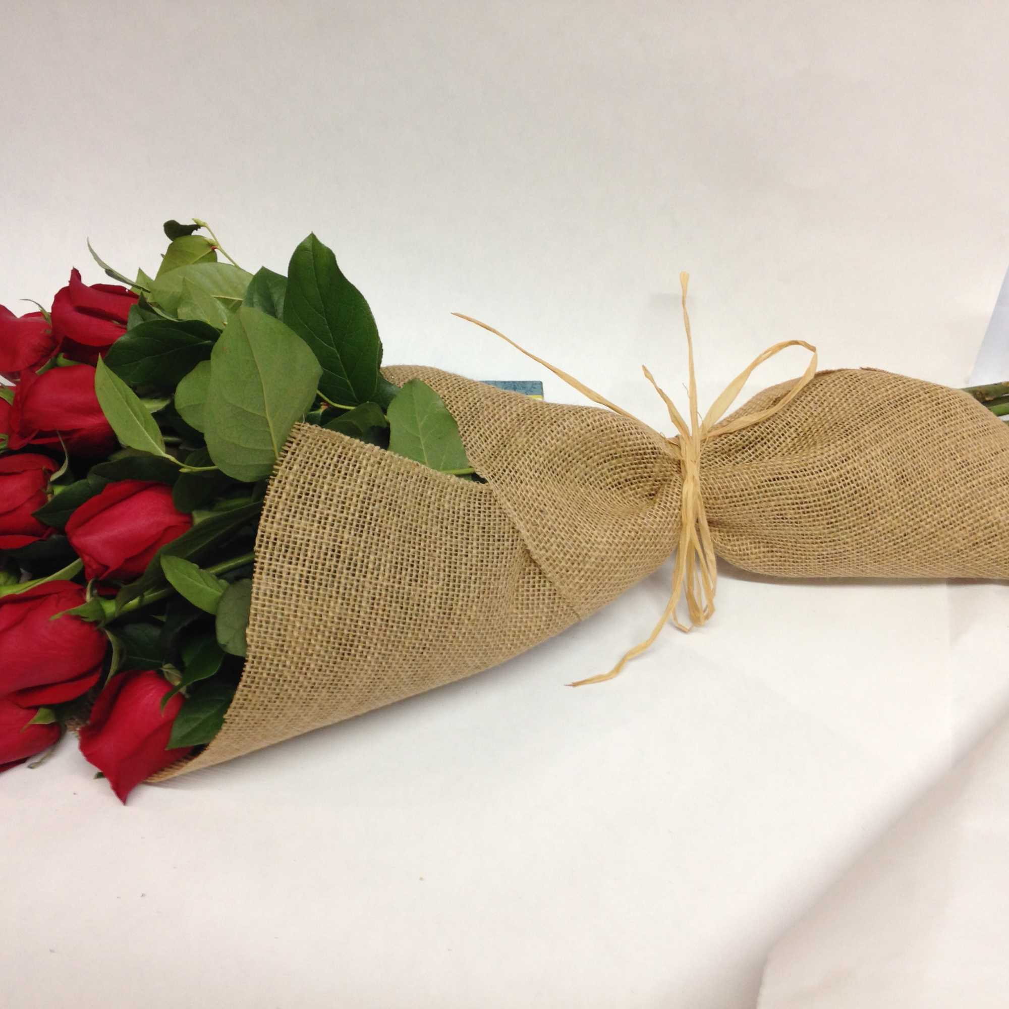 Bouquet of red roses wrapped in burlap