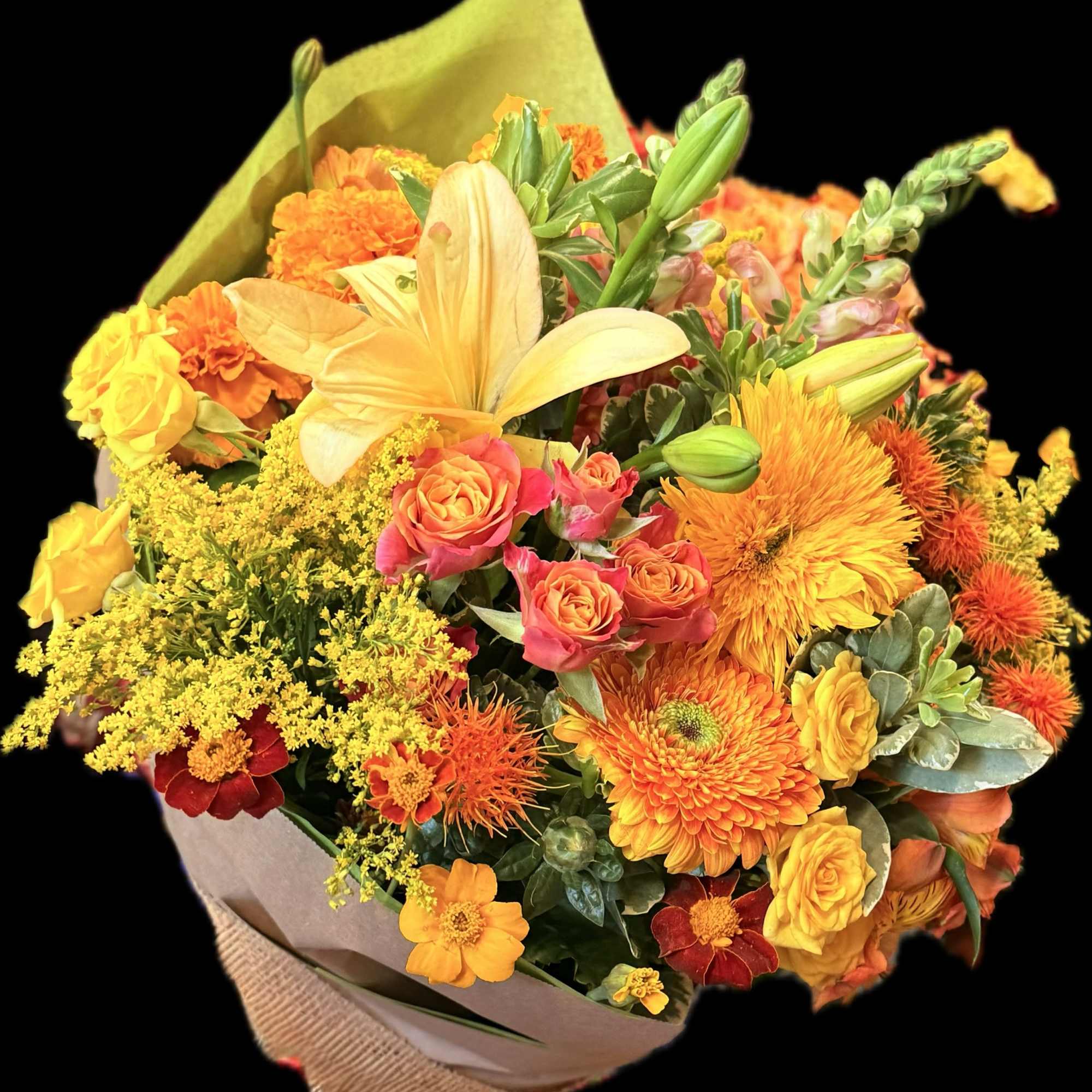 Bouquet of orange, yellow, and pink flowers wrapped in paper