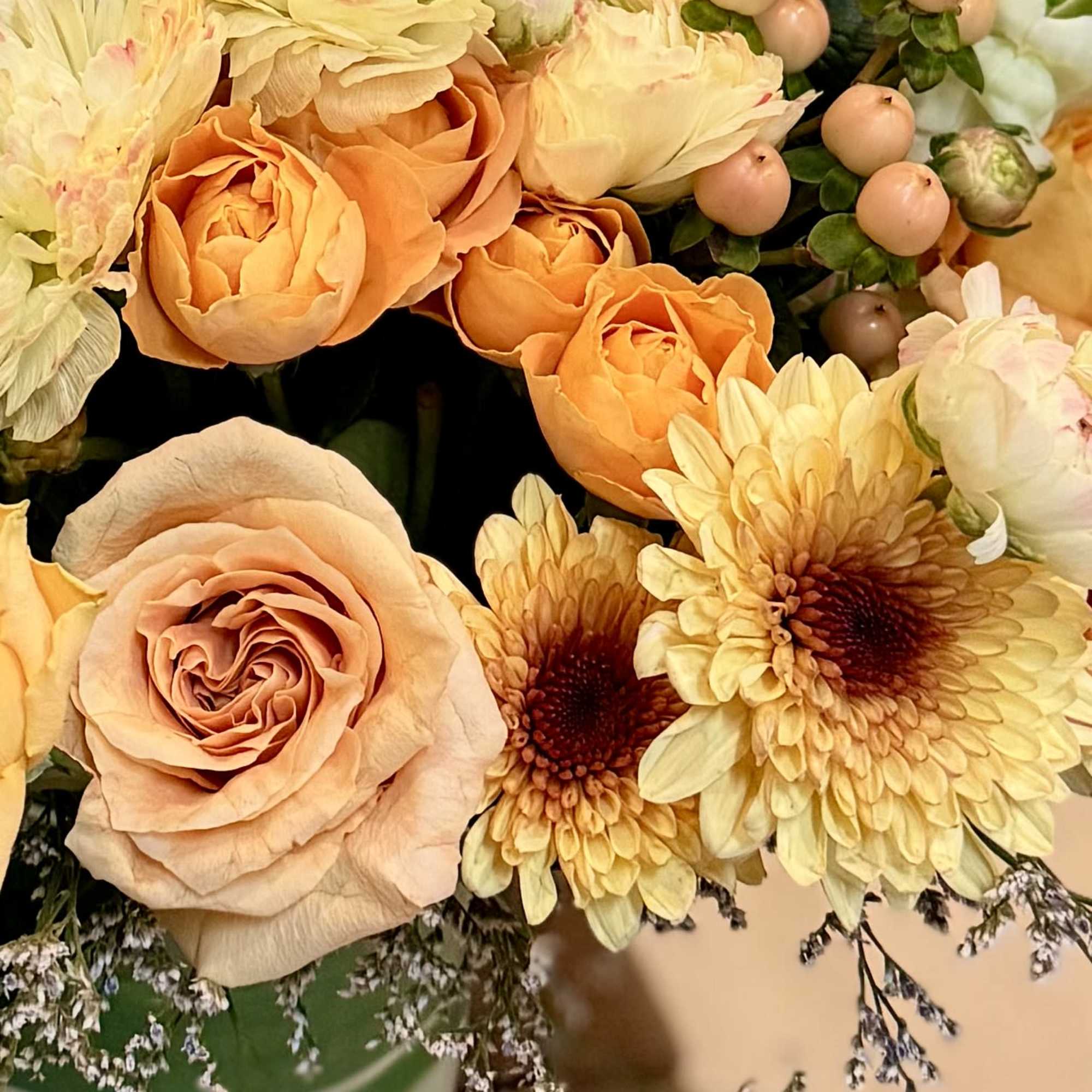 Peach and cream bouquet with roses and chrysanthemums in a vase