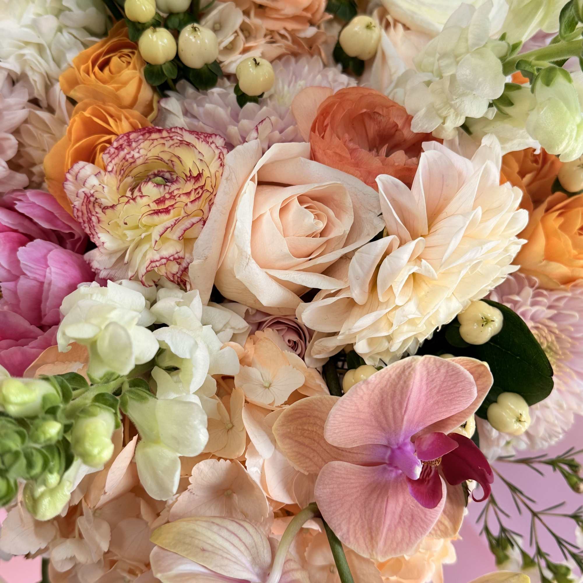Pastel bouquet with roses, orchids, and hydrangeas