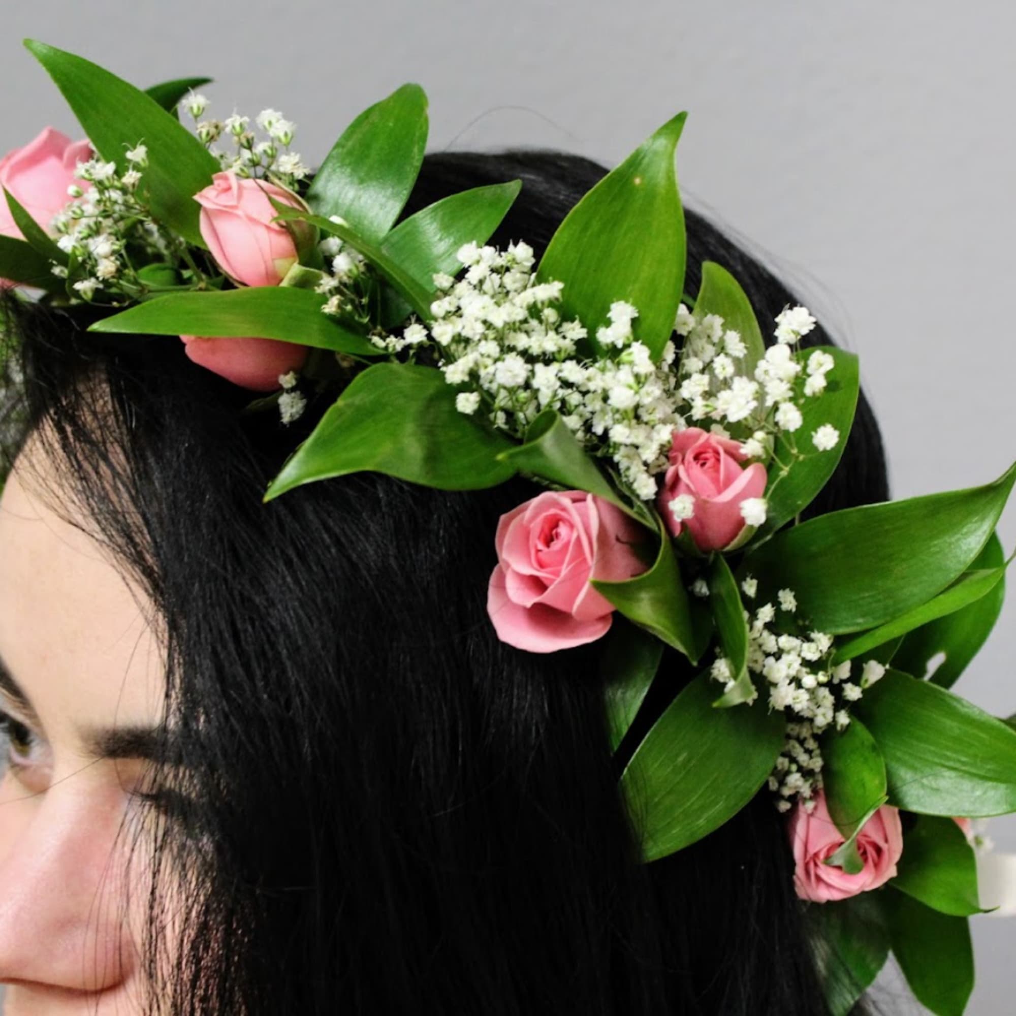 Pink rose flower crown with white filler flowers on dark hair