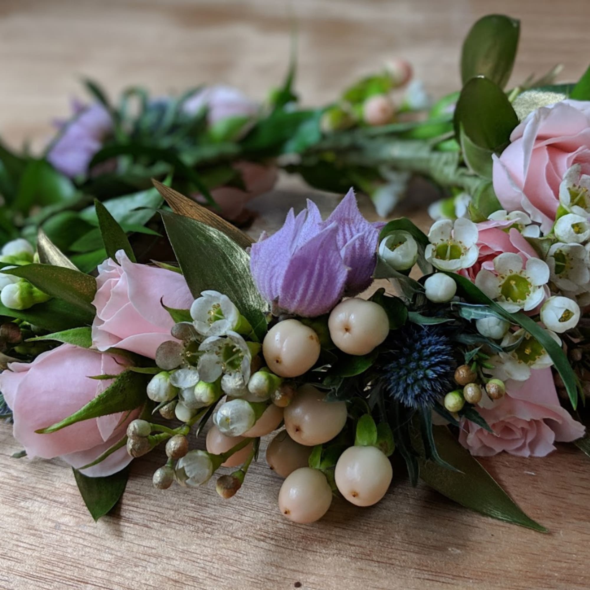 Pink roses and lavender flowers arranged in a floral crown