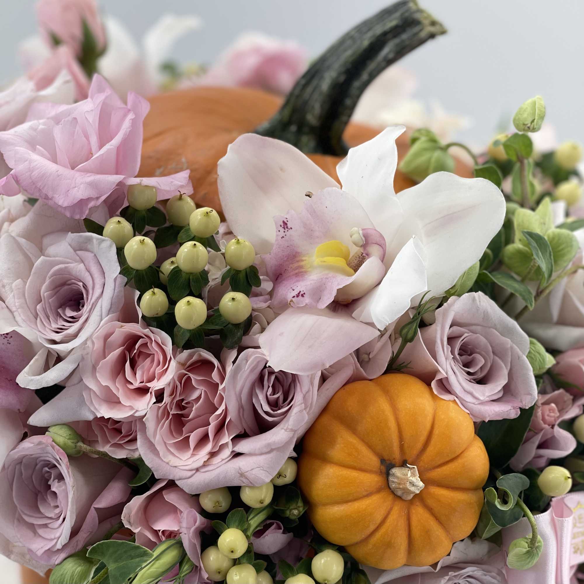 Classic orange pumpkin with an arrangement of fresh pastel flowers, photo 2 of 2