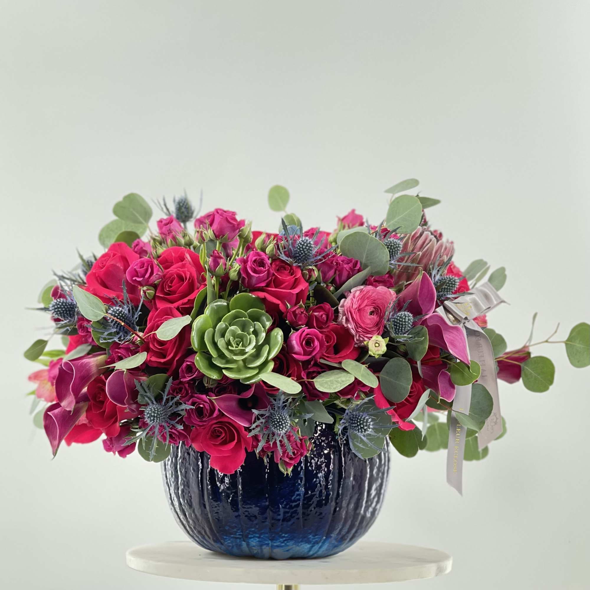 Mix of flowers in a pumpkin