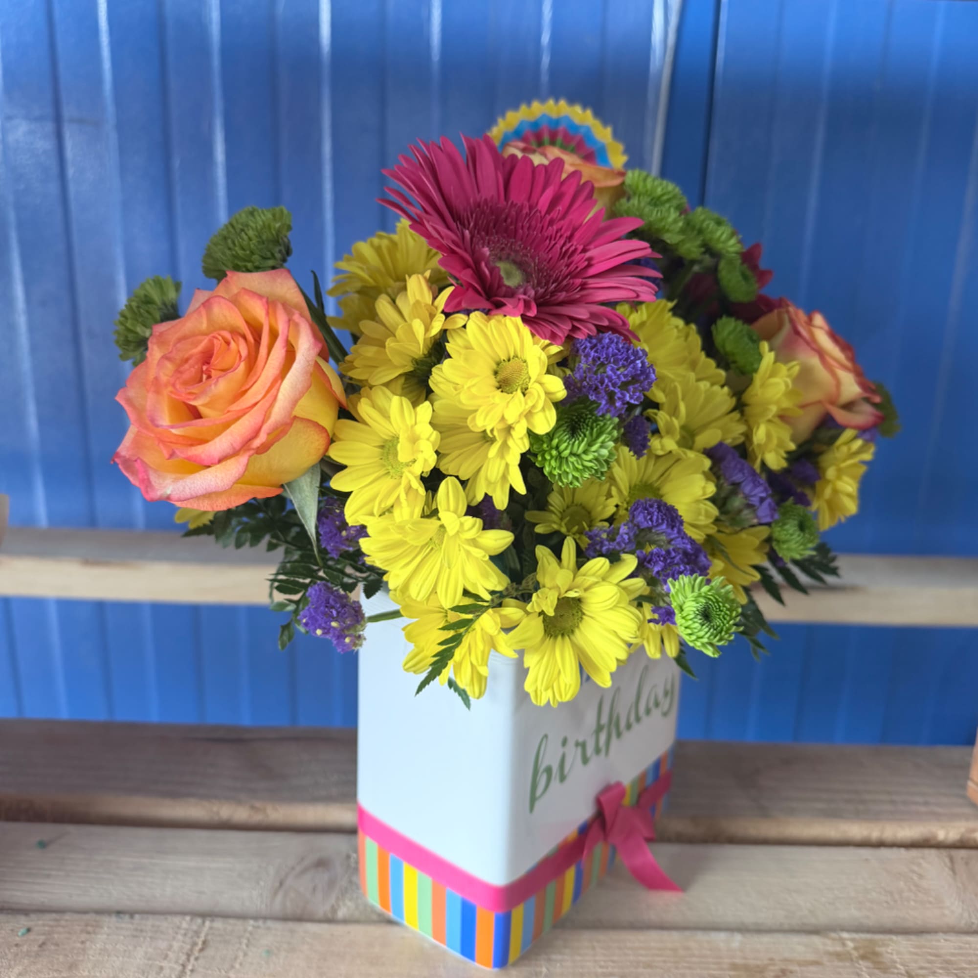 Colorful mixed bouquet in a white birthday box with a pink ribbon