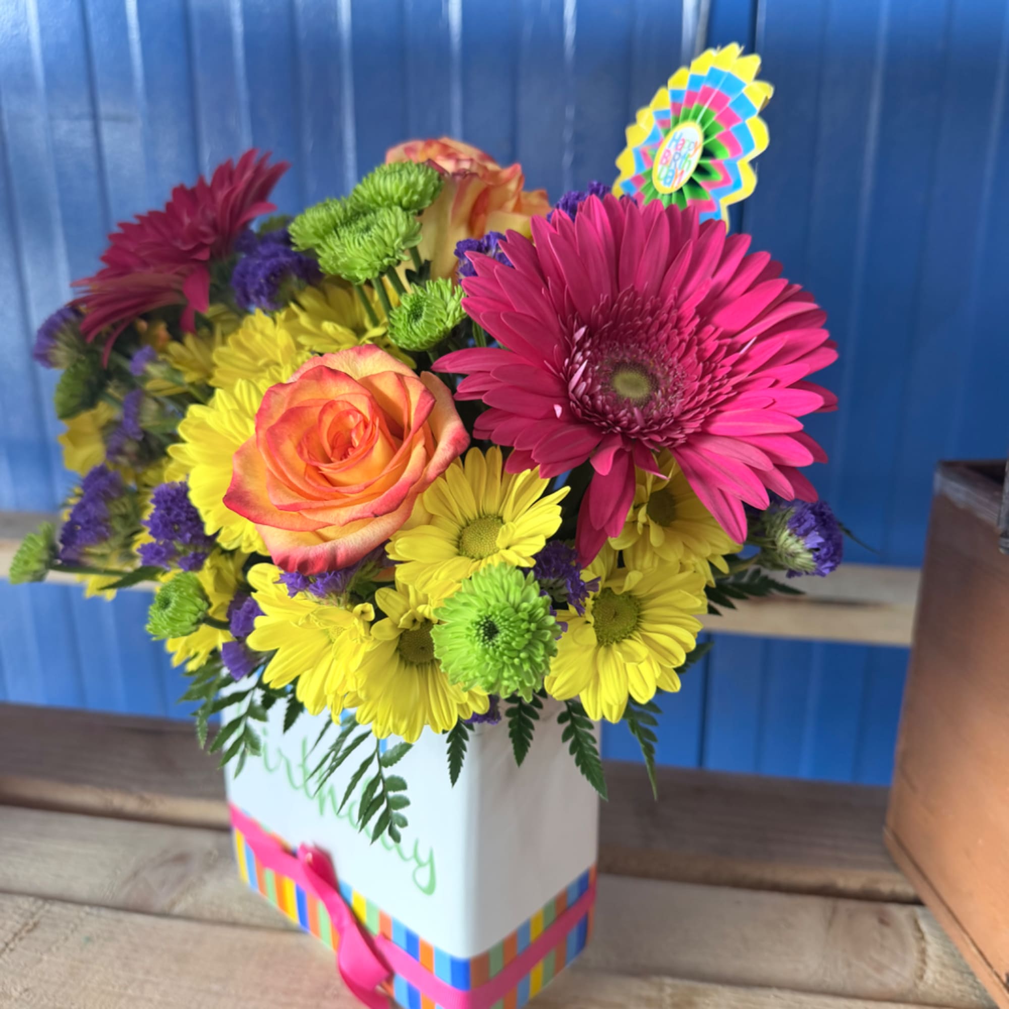 Bright mixed bouquet in a white gift box with a birthday topper