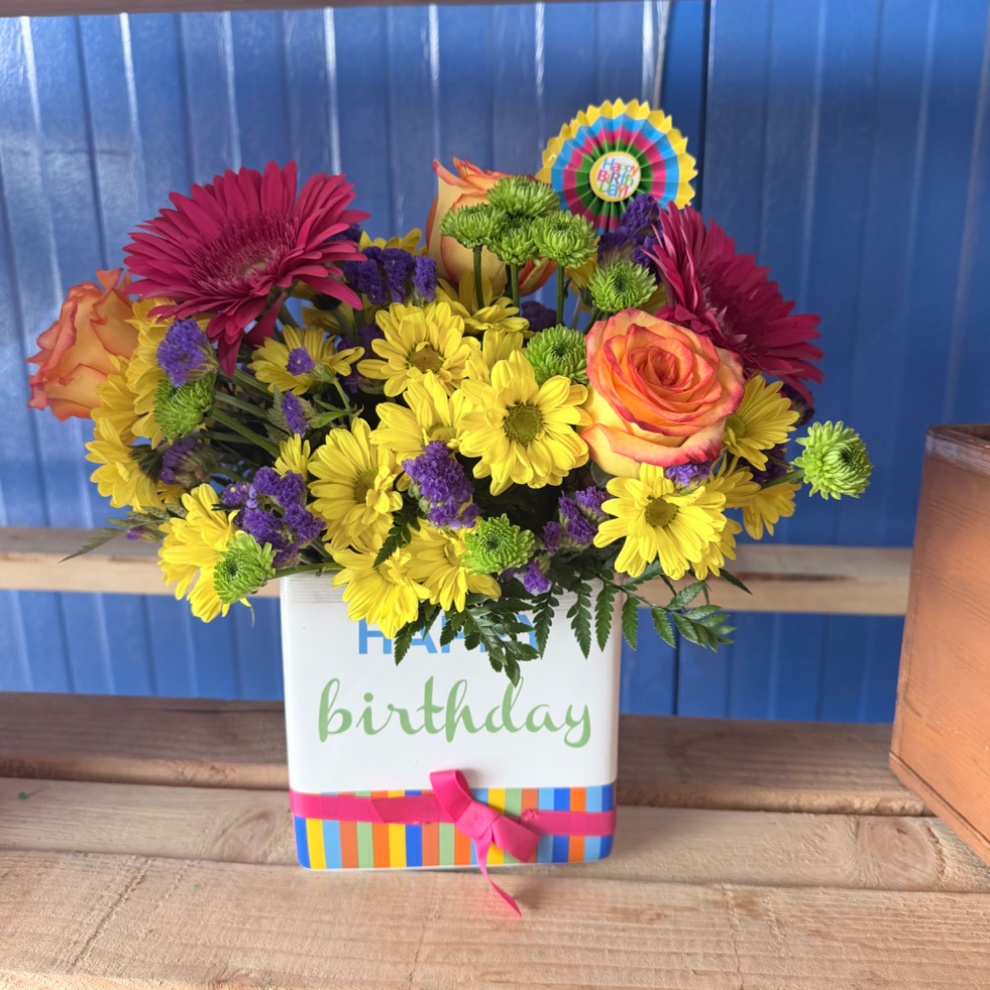 Colorful birthday flower arrangement in a white gift box with a ribbon