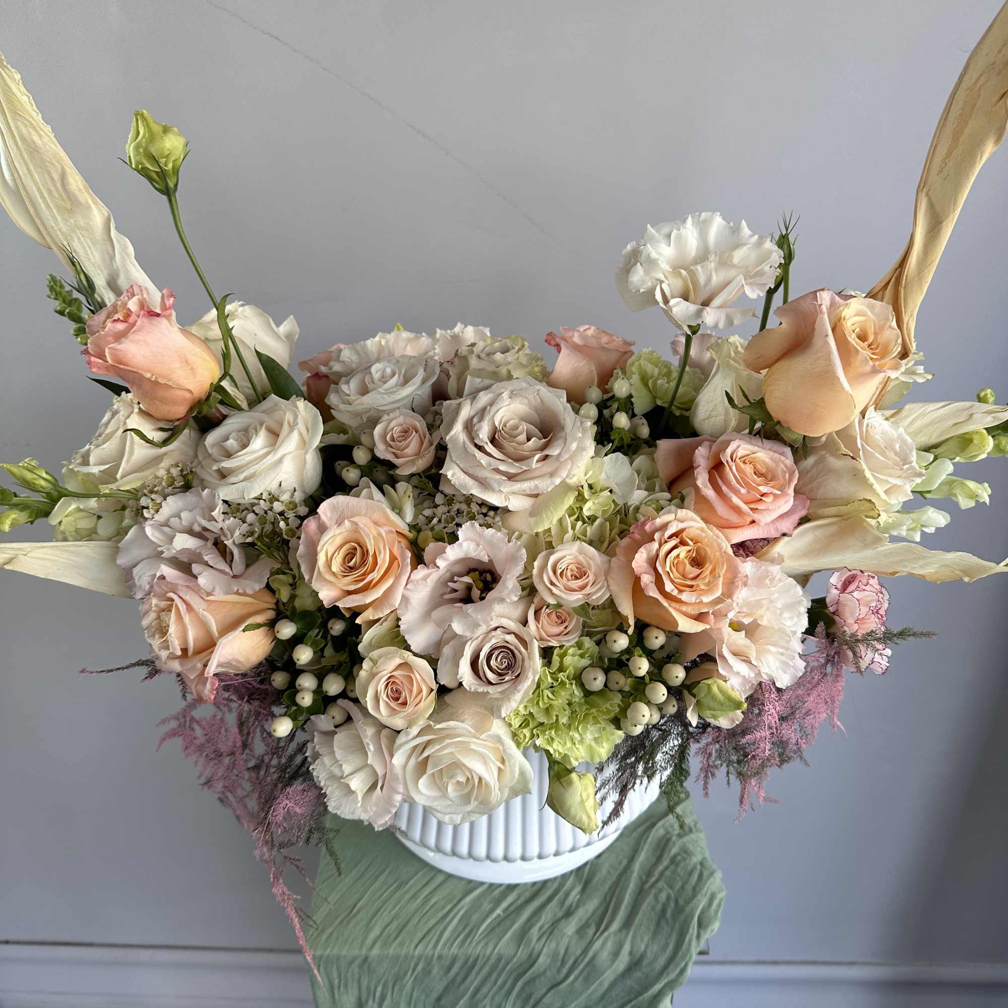 This elegant floral arrangement features soft peach and blush roses, complemented by, photo 2 of 2