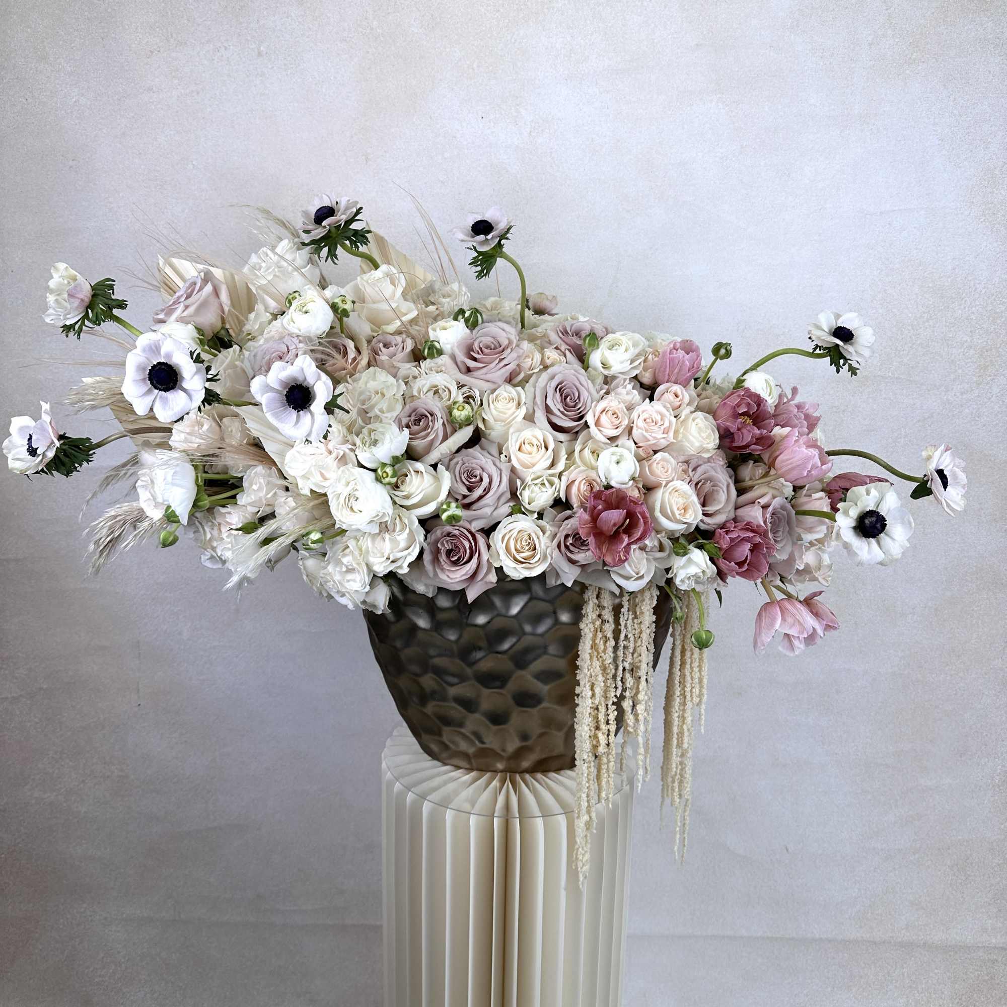 A stylish fusion of fresh, high-end flowers designed in a statement vase.