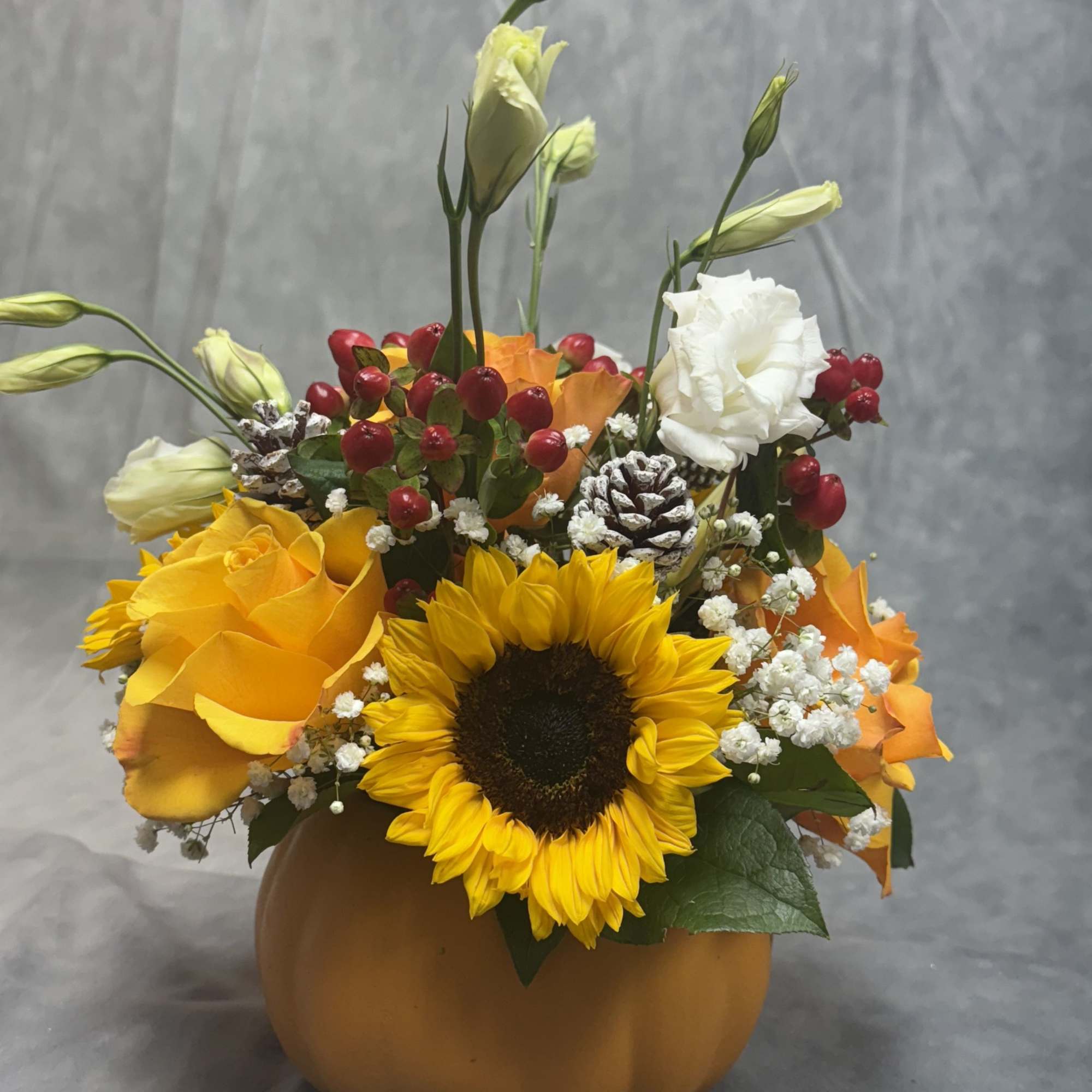 Celebrate the beauty of fall with this charming Harvest Pumpkin arrangement. Designed