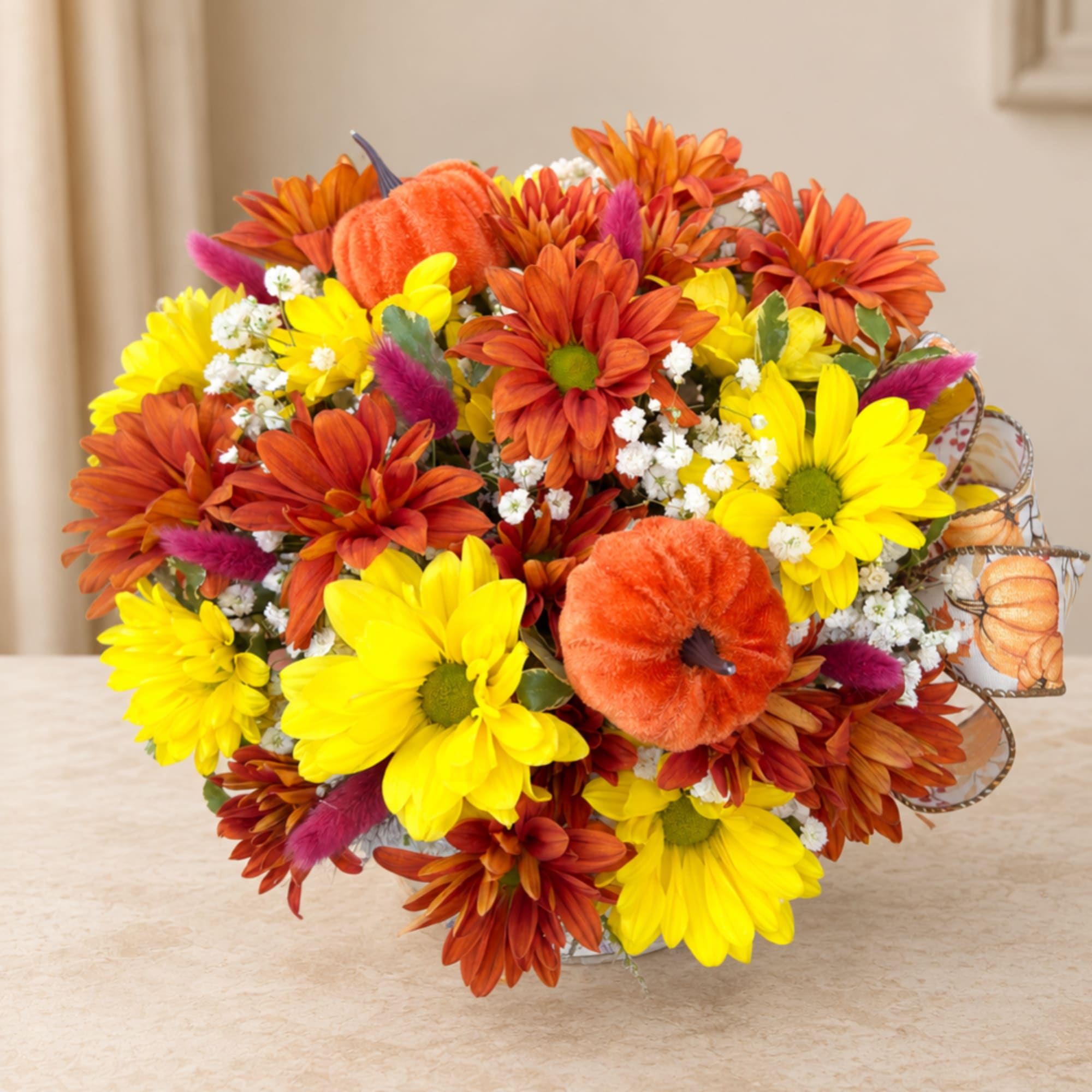 Bouquet of yellow and orange daisies with small white filler flowers