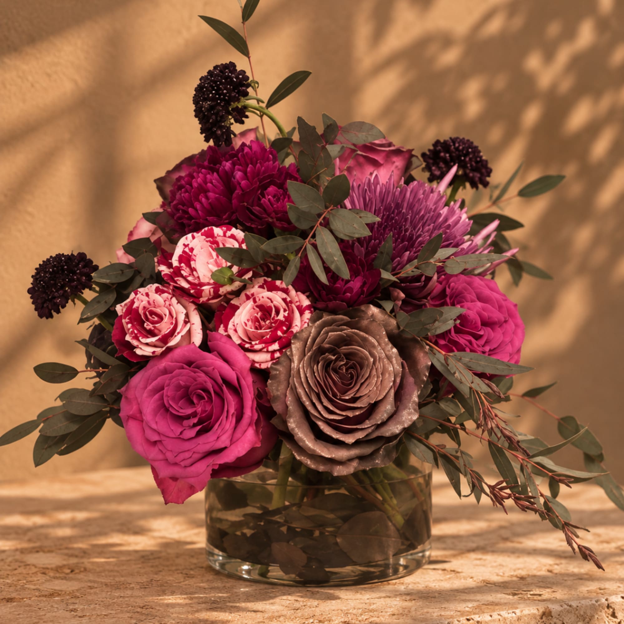 Pink and purple floral arrangement in a glass vase