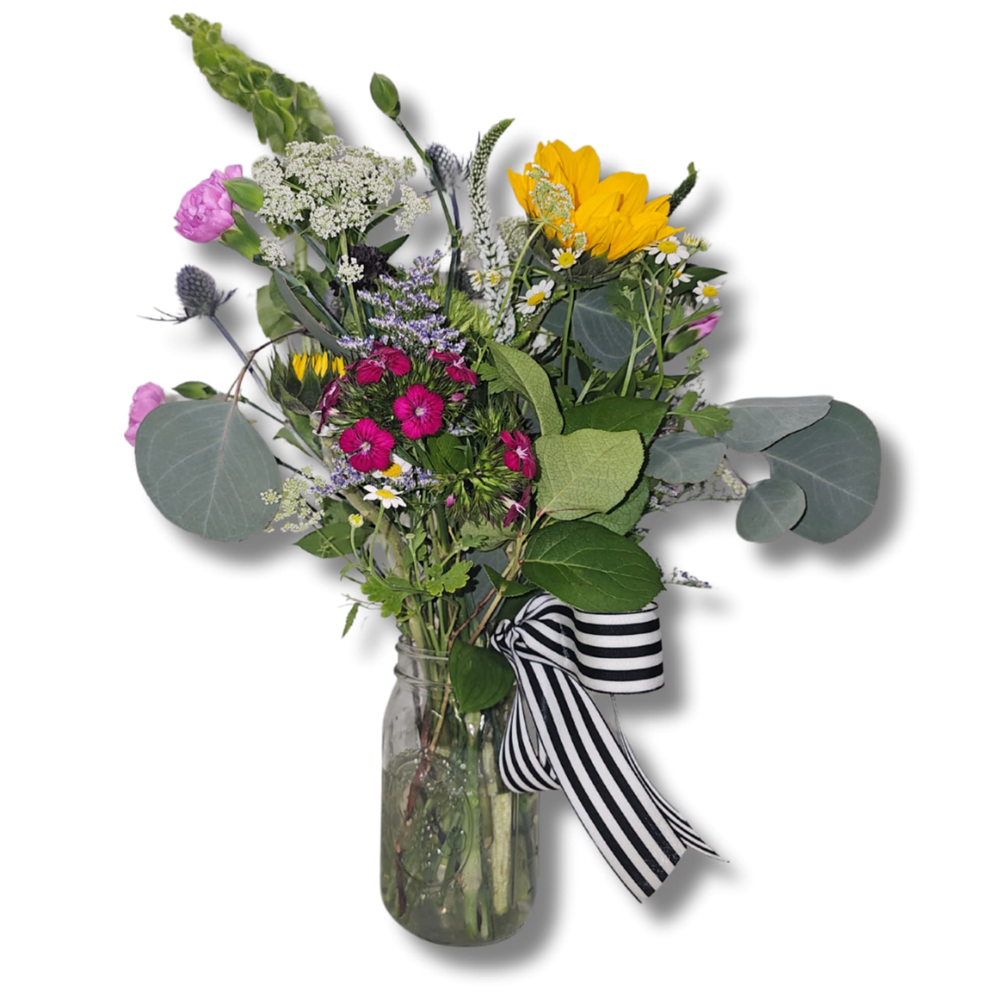 Mixed bouquet in a glass jar with a striped ribbon