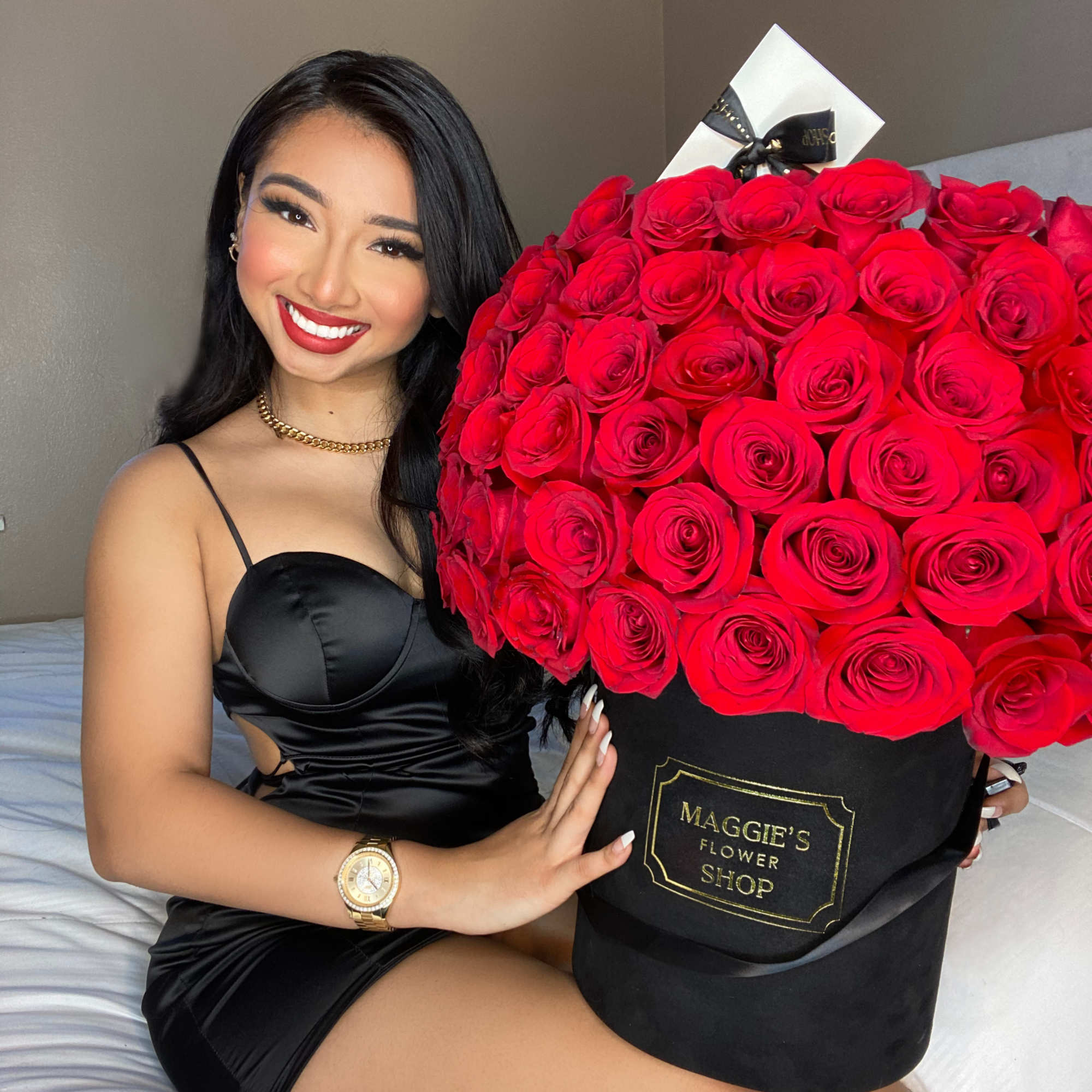 Large bouquet of red roses in a black hat box