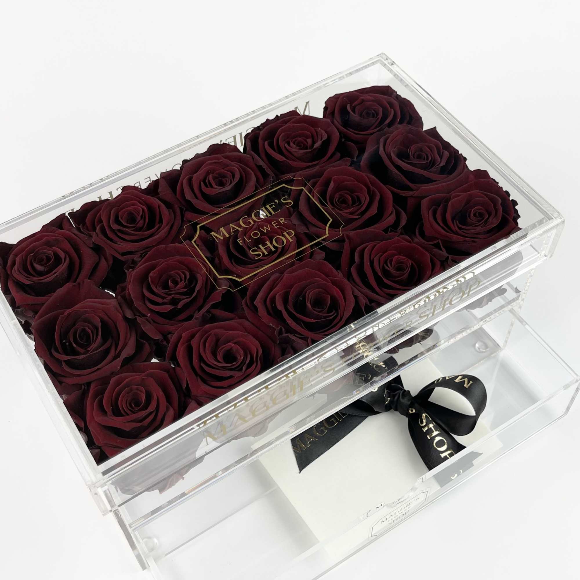 Box of deep red roses in a clear acrylic case