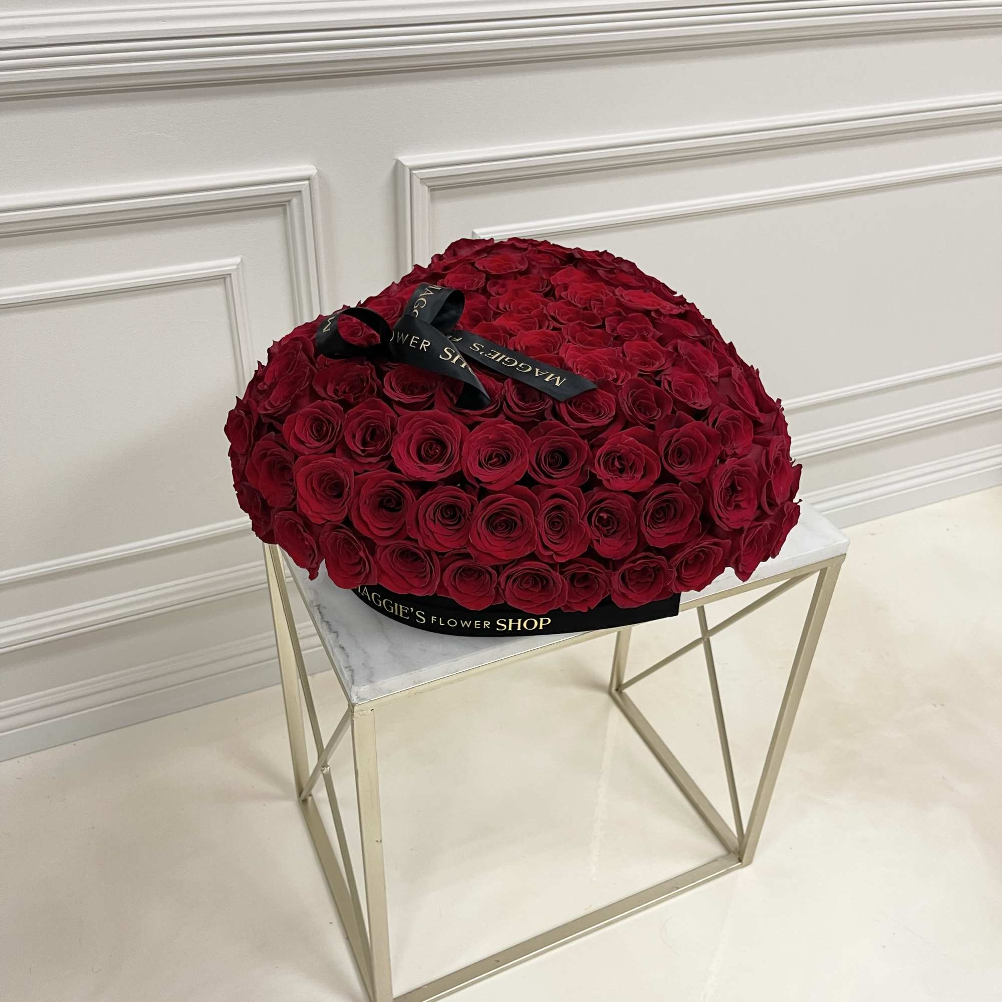 Large dome bouquet of red roses with a black ribbon