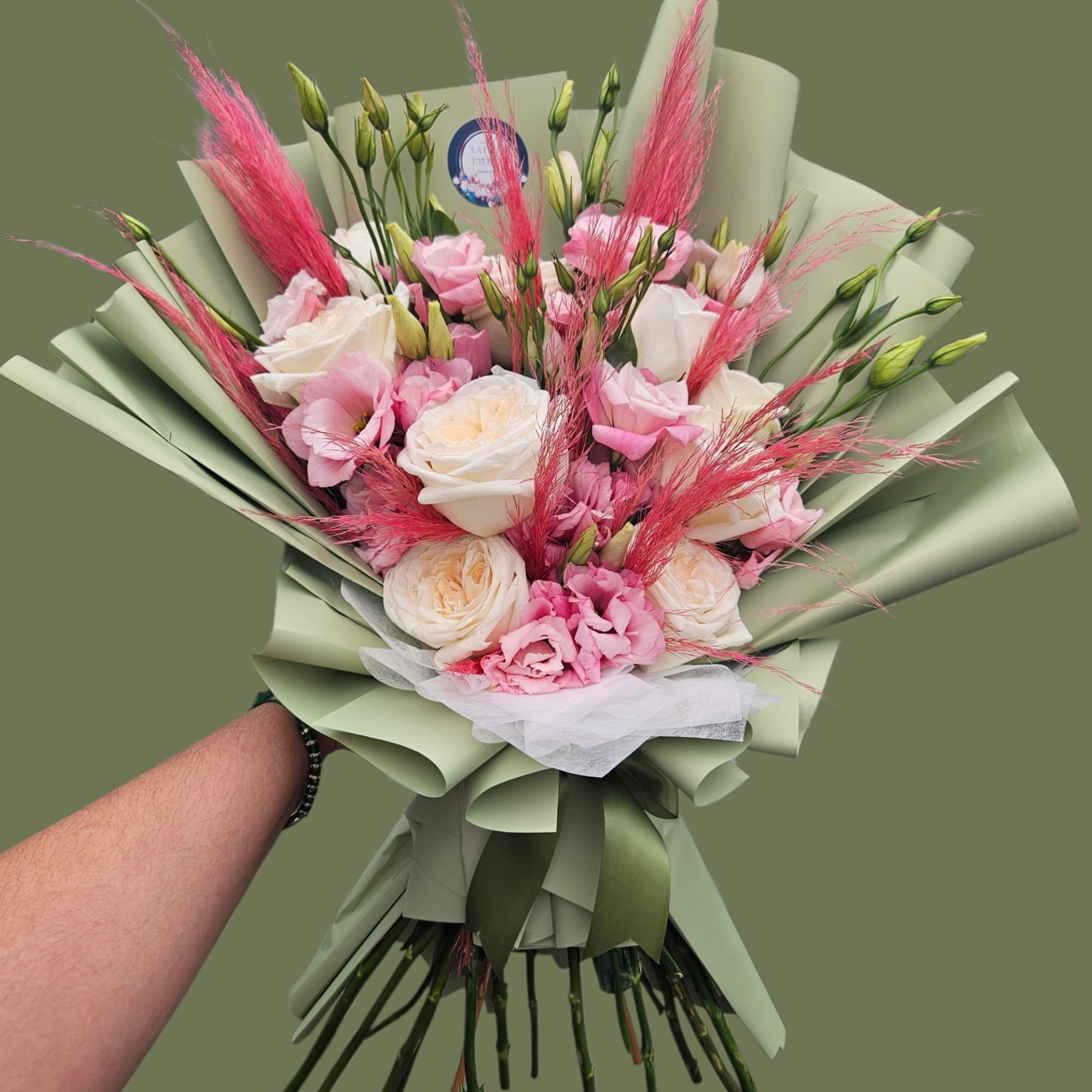Blush pink and creamy white roses mingle with soft pink lisianthus and