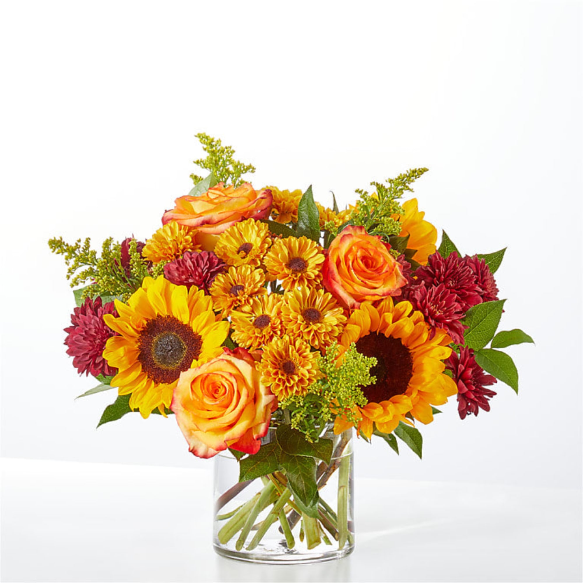 Bouquet of sunflowers, orange roses, and red mums in a clear glass vase, photo 3 of 4