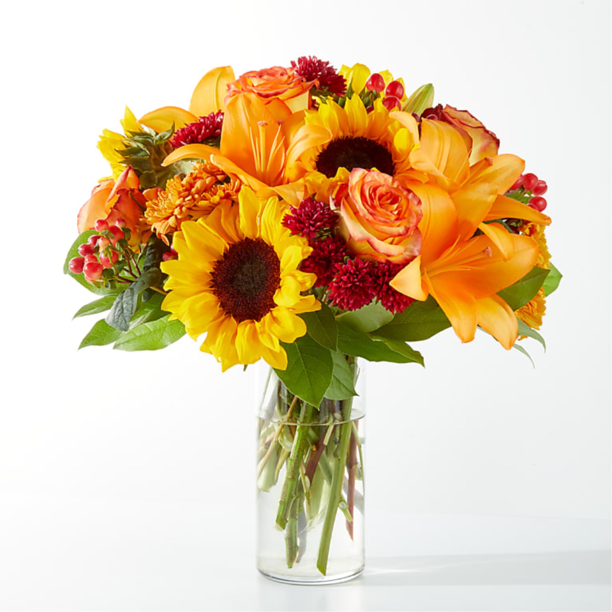 Bouquet of orange and yellow flowers in a clear glass vase