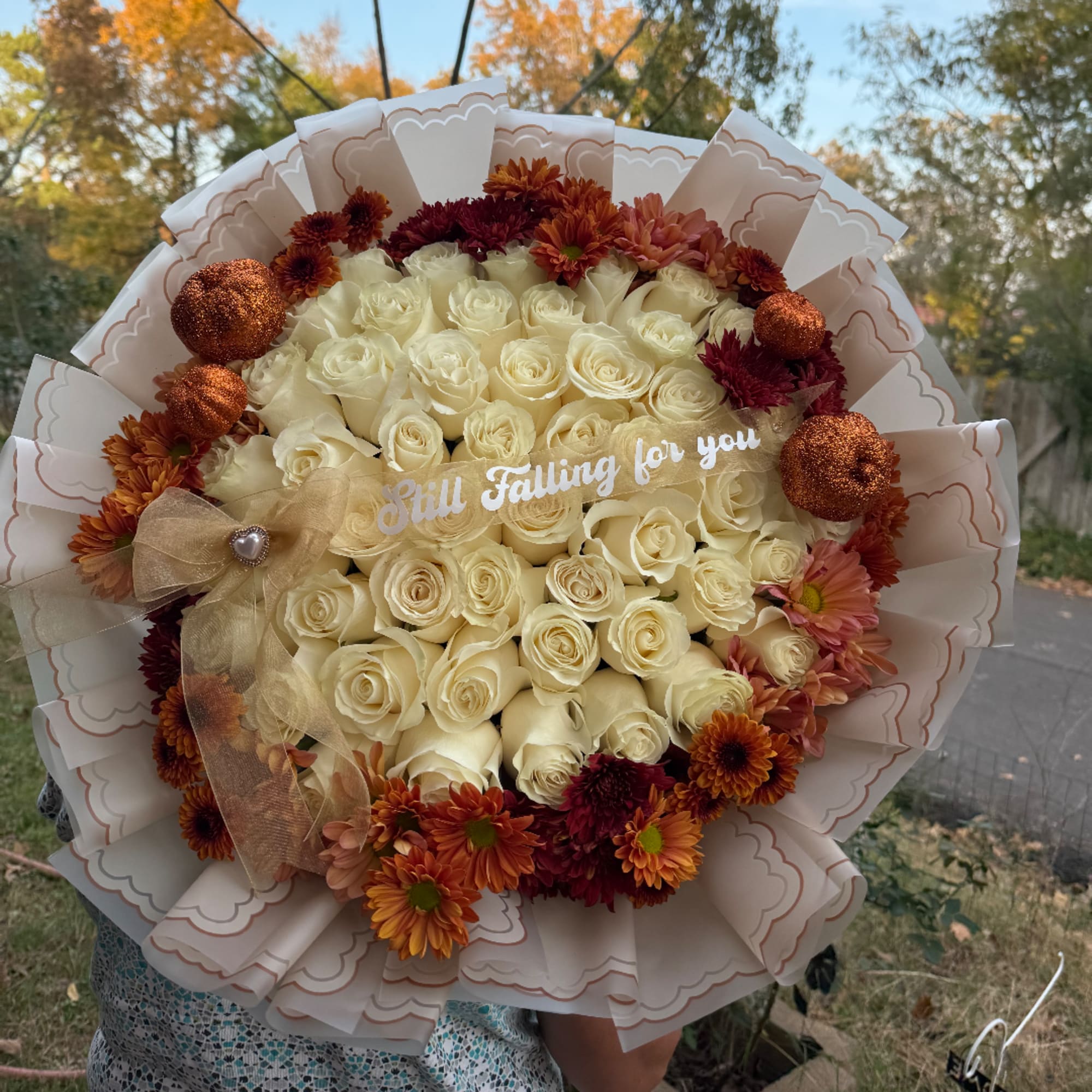 Large bouquet of cream roses with orange and burgundy flowers
