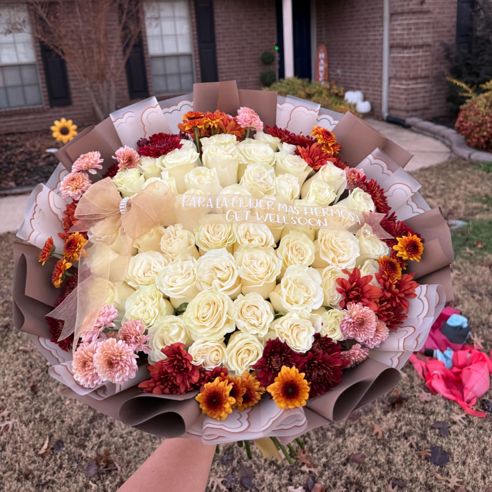 Large bouquet of cream roses with red, orange, and pink flowers