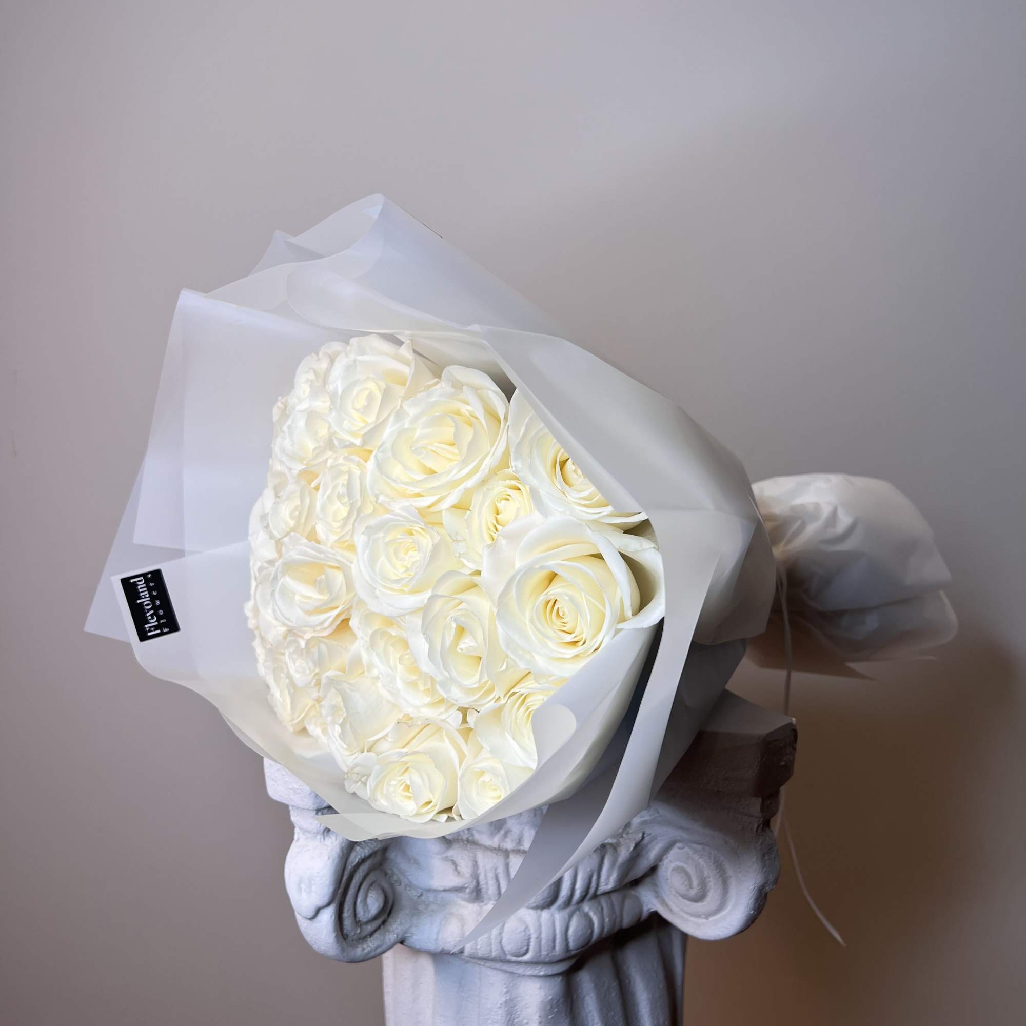 Bouquet of white roses wrapped in translucent paper, photo 3 of 3