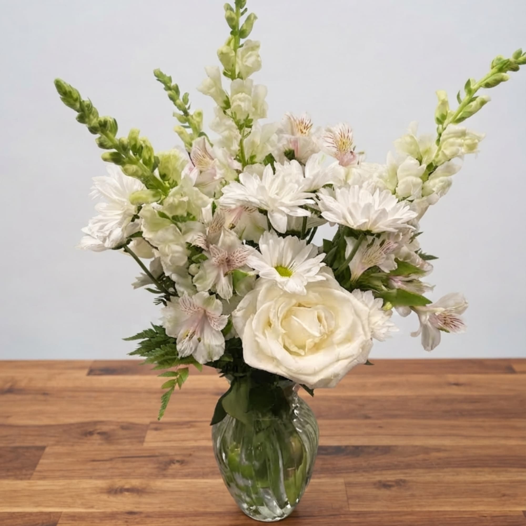 White floral arrangement in a clear glass vase