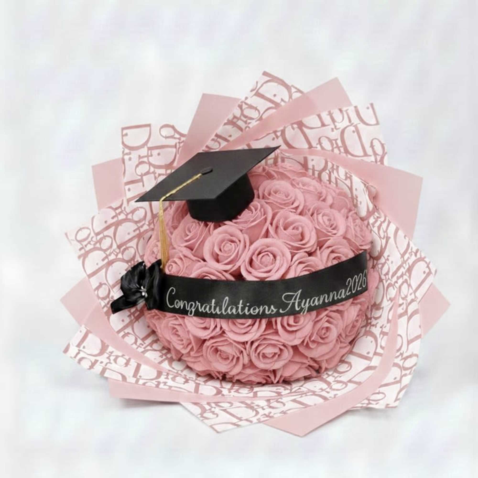 Pink rose bouquet with a graduation cap and congratulatory ribbon