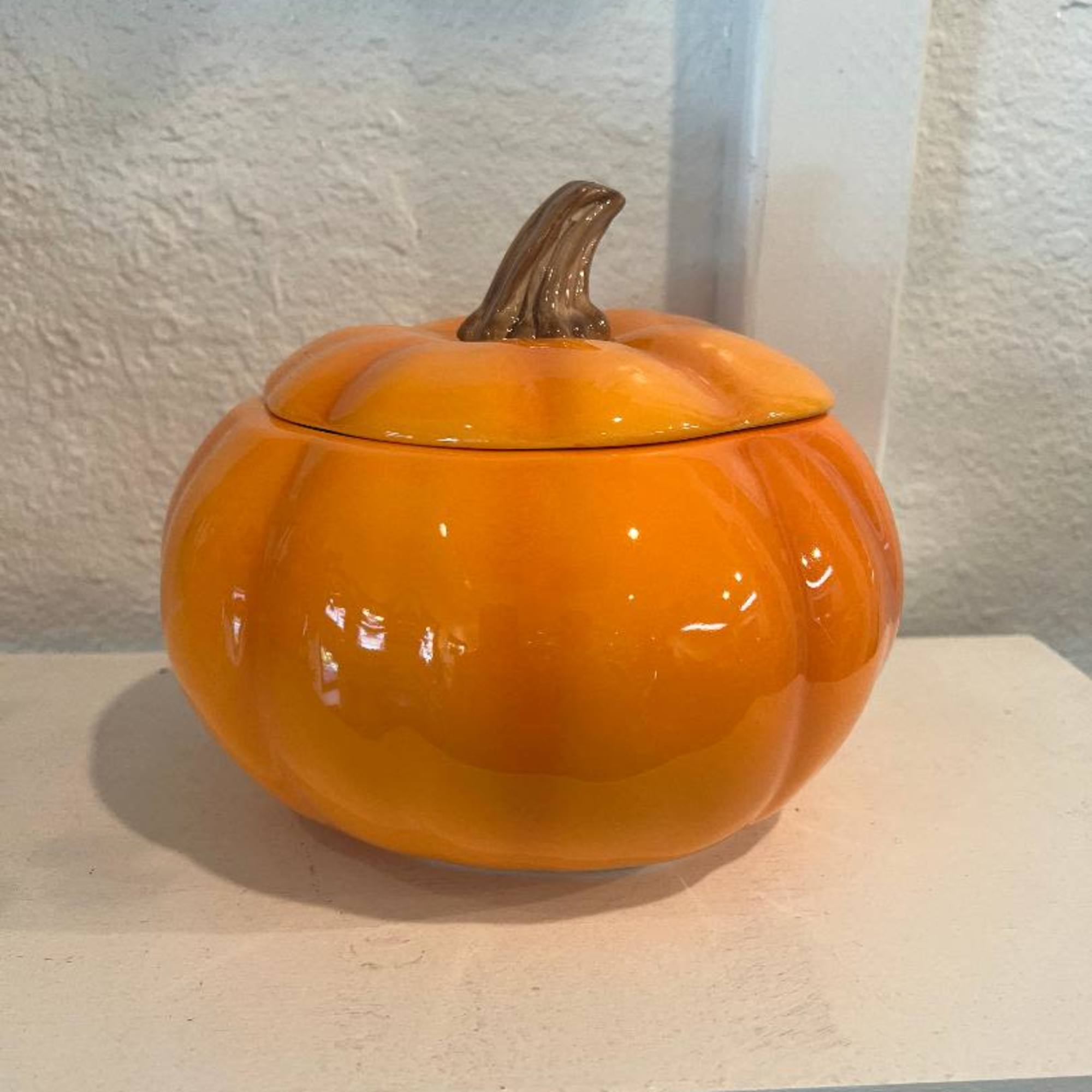 Orange pumpkin-shaped ceramic container with a lid