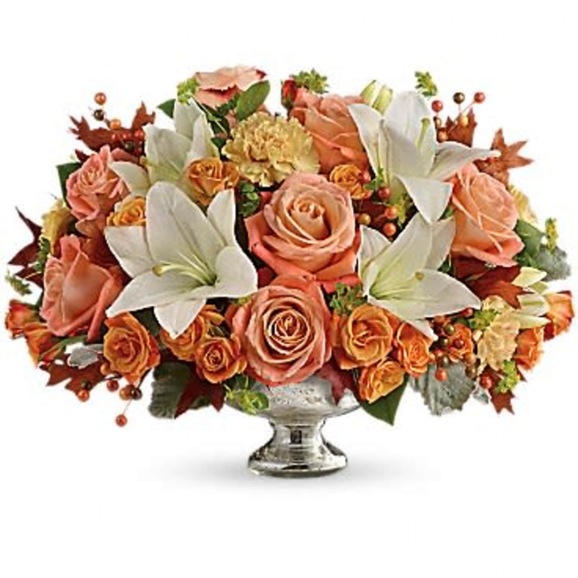 Peach roses and white lilies arranged in a silver pedestal vase