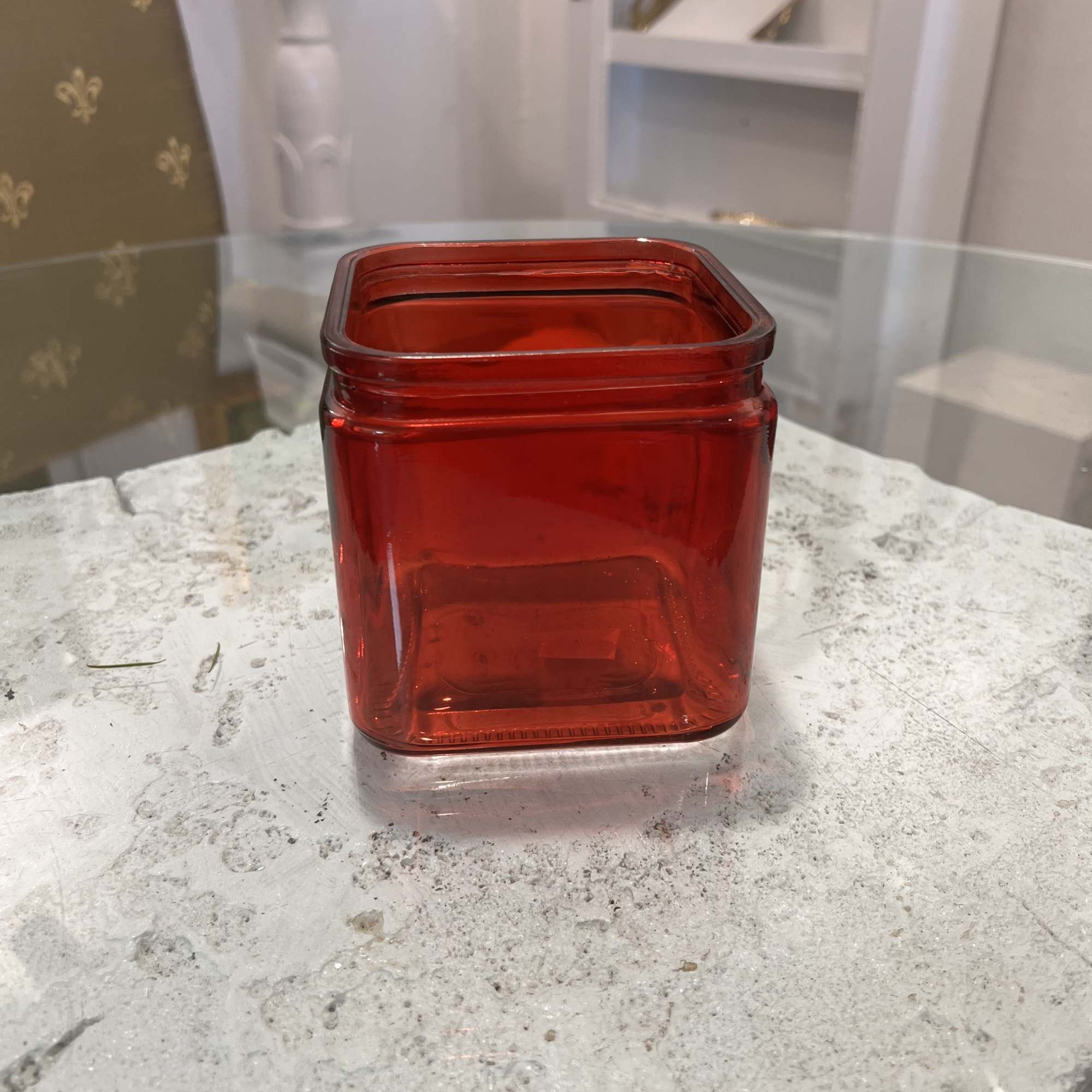 Red square glass vase on a tabletop