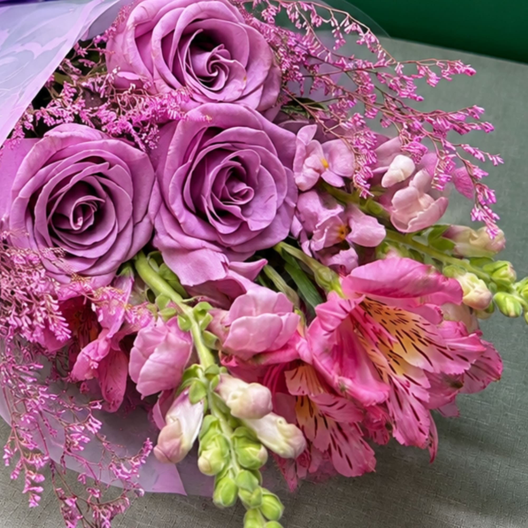 Bouquet of lavender roses and pink flowers with ribbon wrap