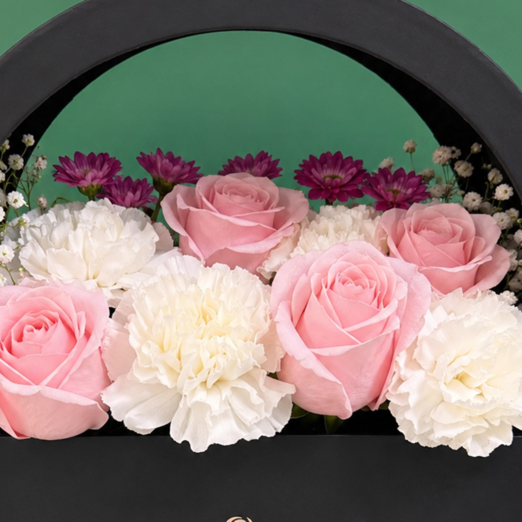 Pink roses and white carnations in a black arched box