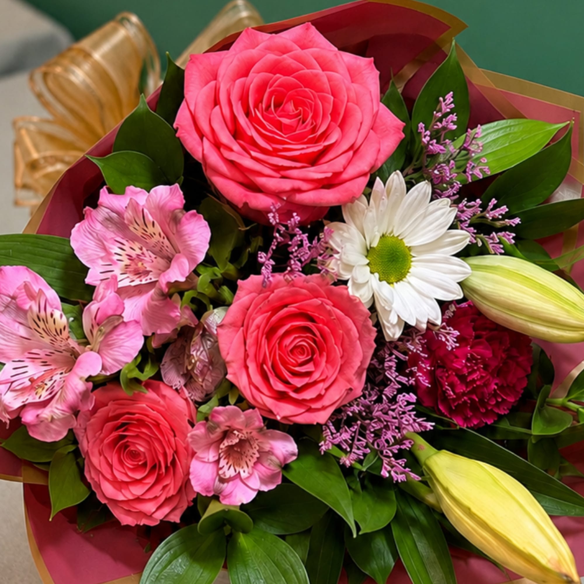 Bouquet of pink roses, pink alstroemeria, and white daisy flowers