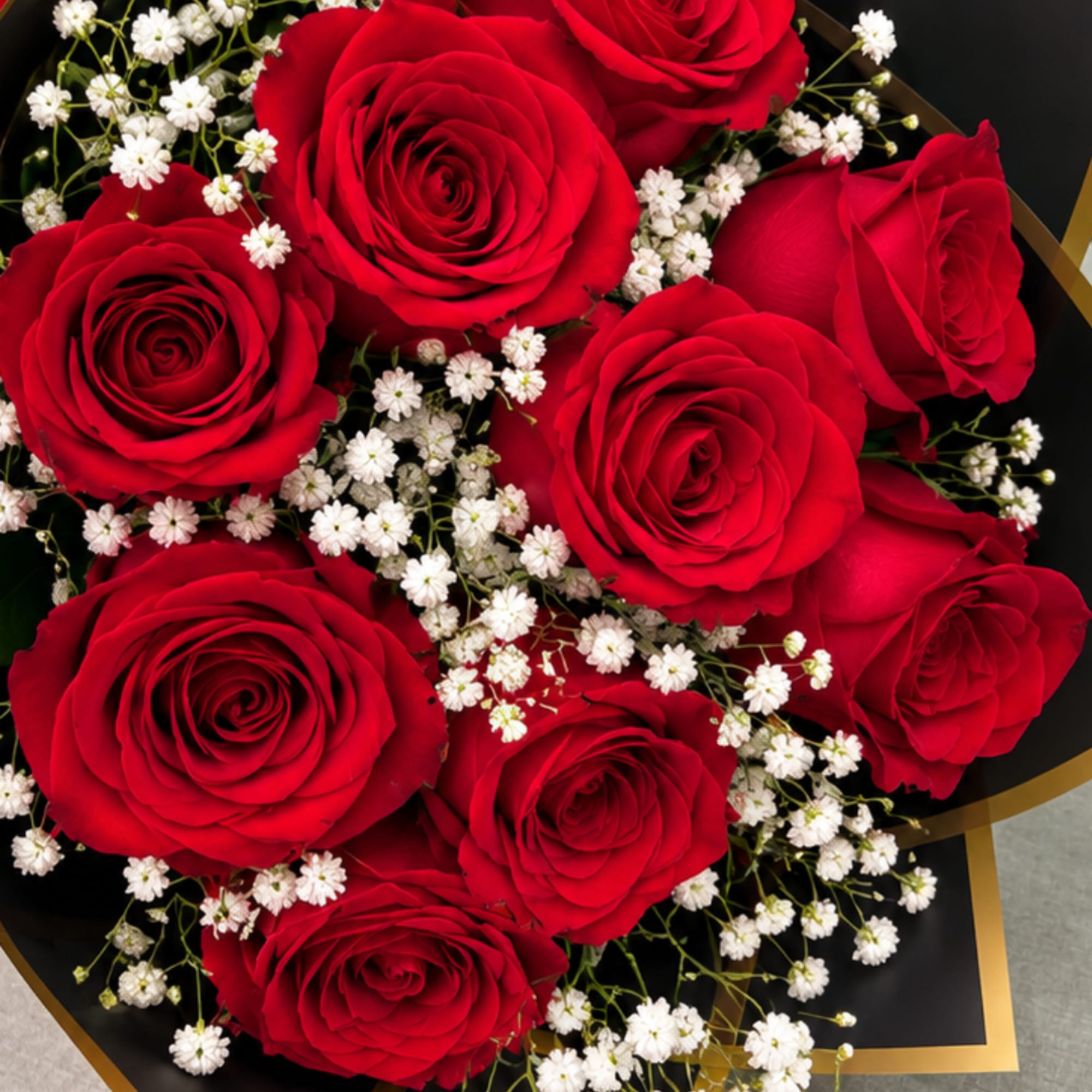 Bouquet of red roses with small white filler flowers