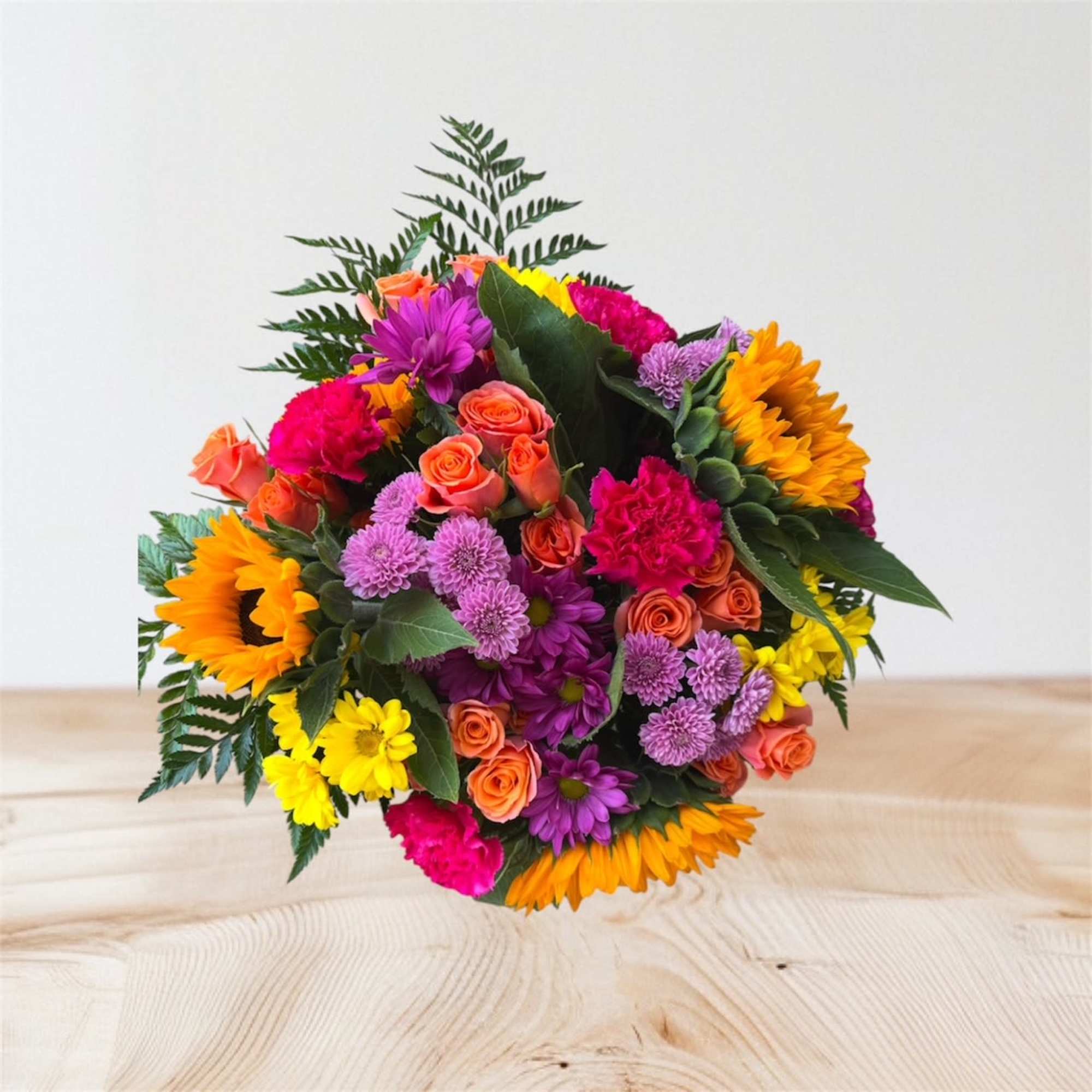 Colorful bouquet of sunflowers, roses, and daisies