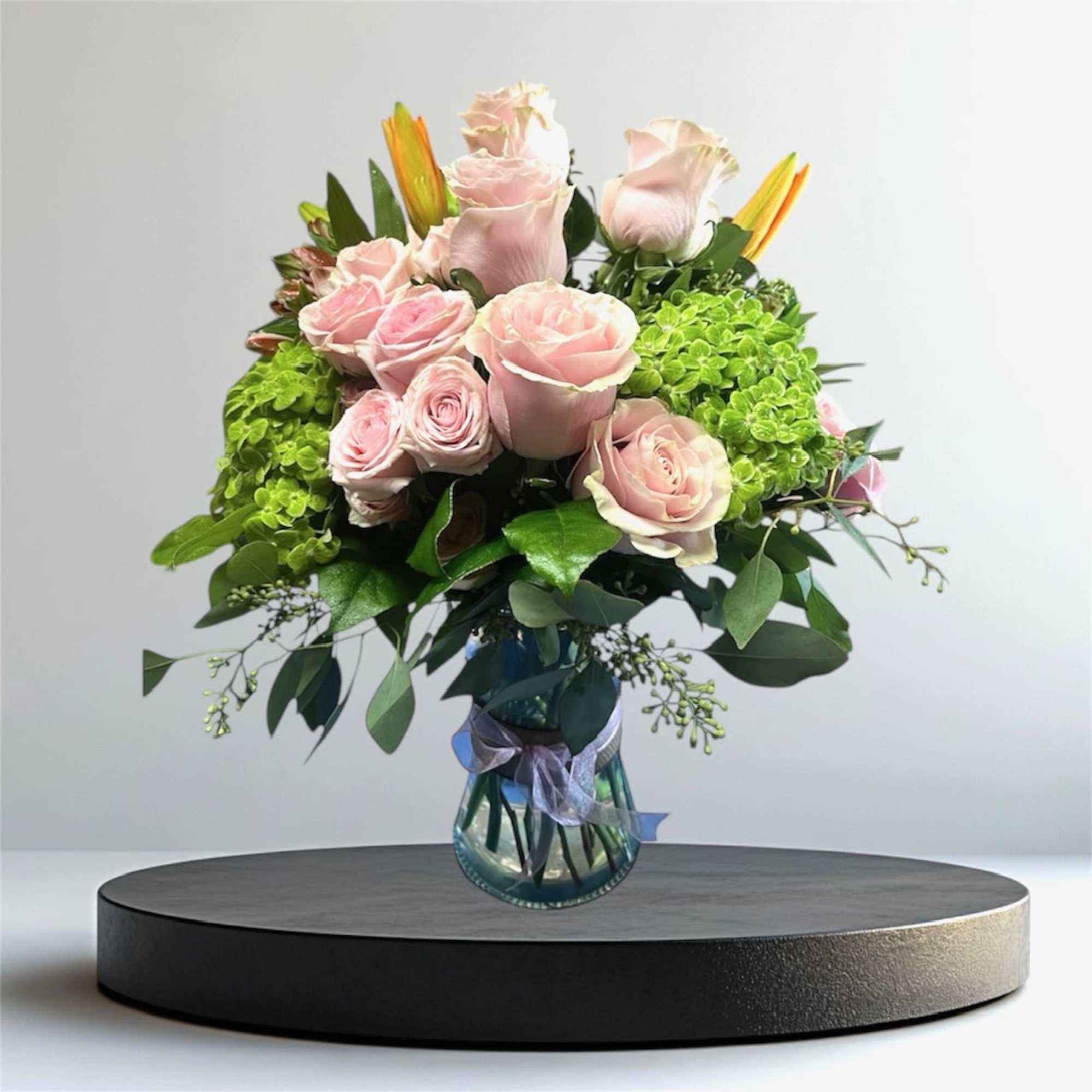 Pink roses and green hydrangeas in a glass vase