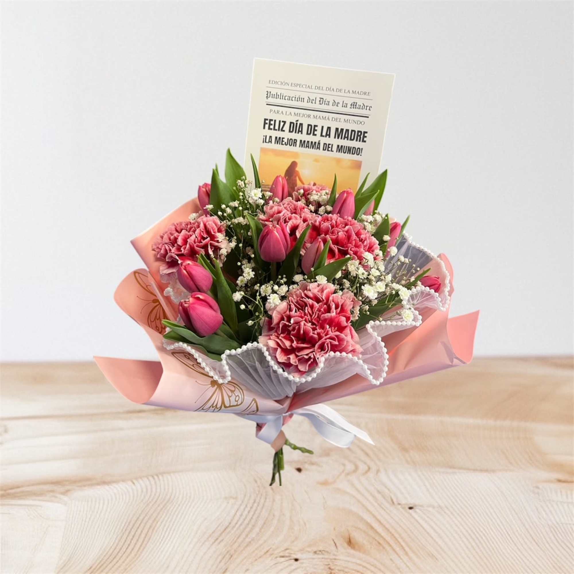 Mother's Day bouquet of pink carnations and tulips with a card in pink wrap