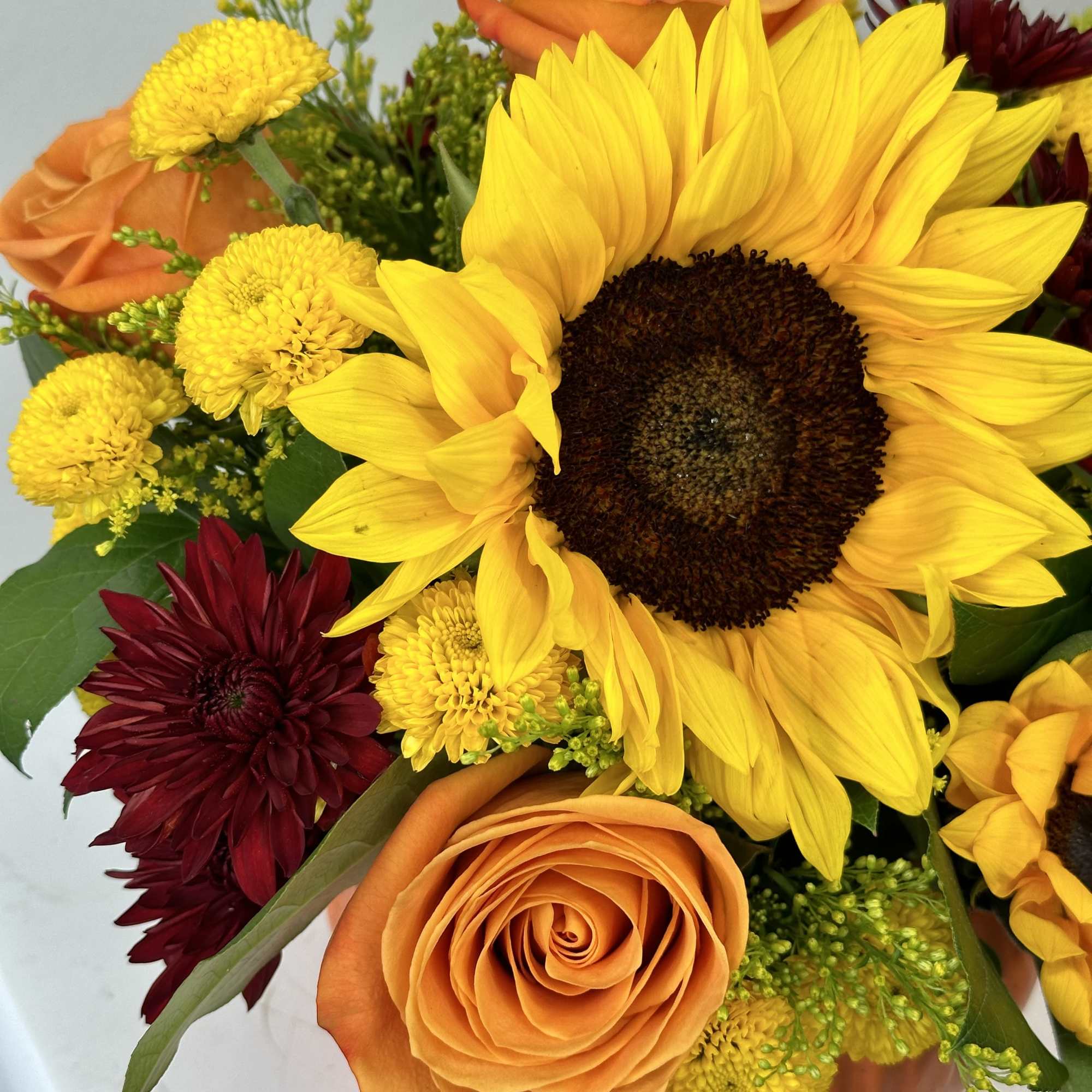 Bouquet with sunflowers, orange roses, and burgundy mums