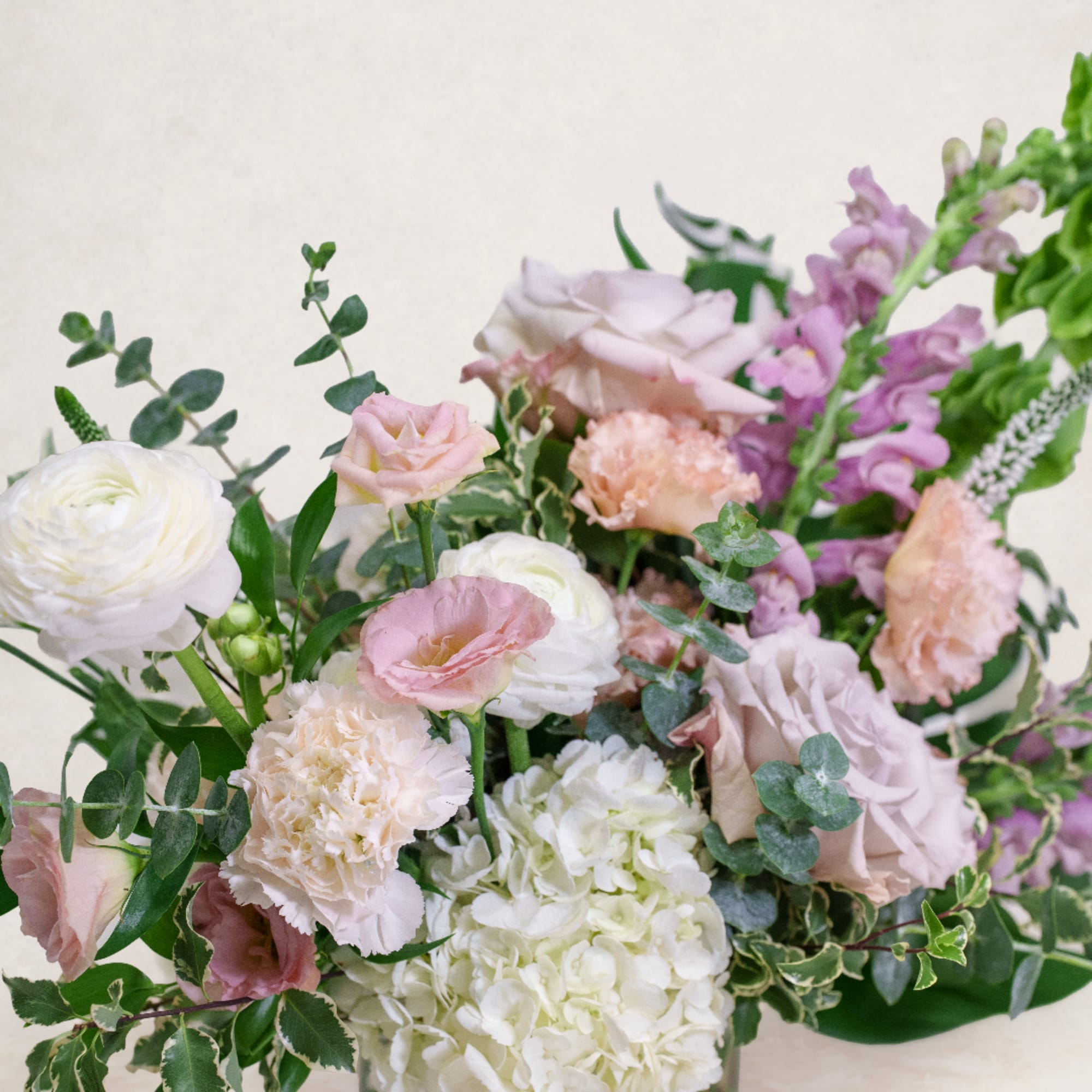 Pastel bouquet with white hydrangea, pink roses, and carnations