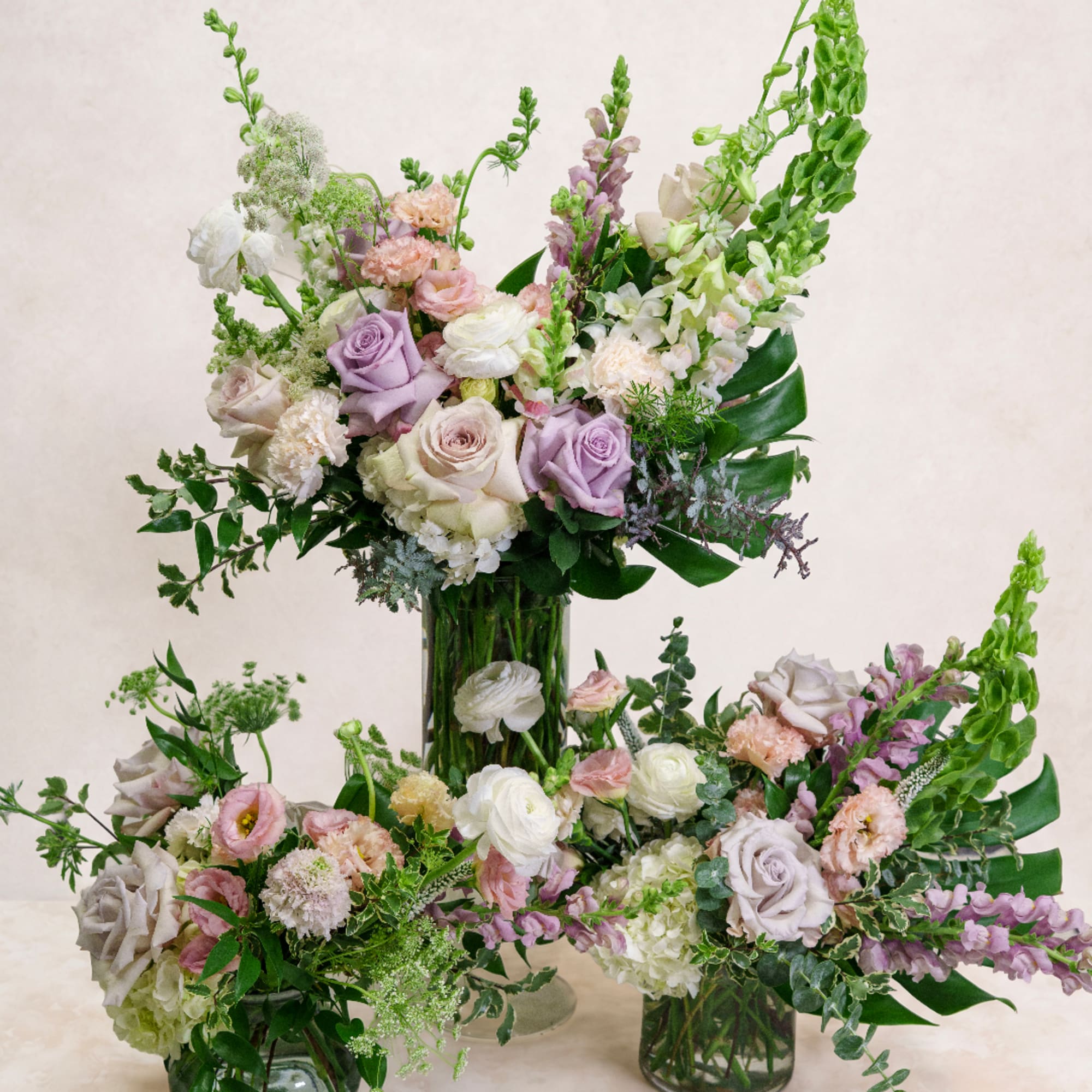 Pastel rose and snapdragon arrangement in a clear glass vase