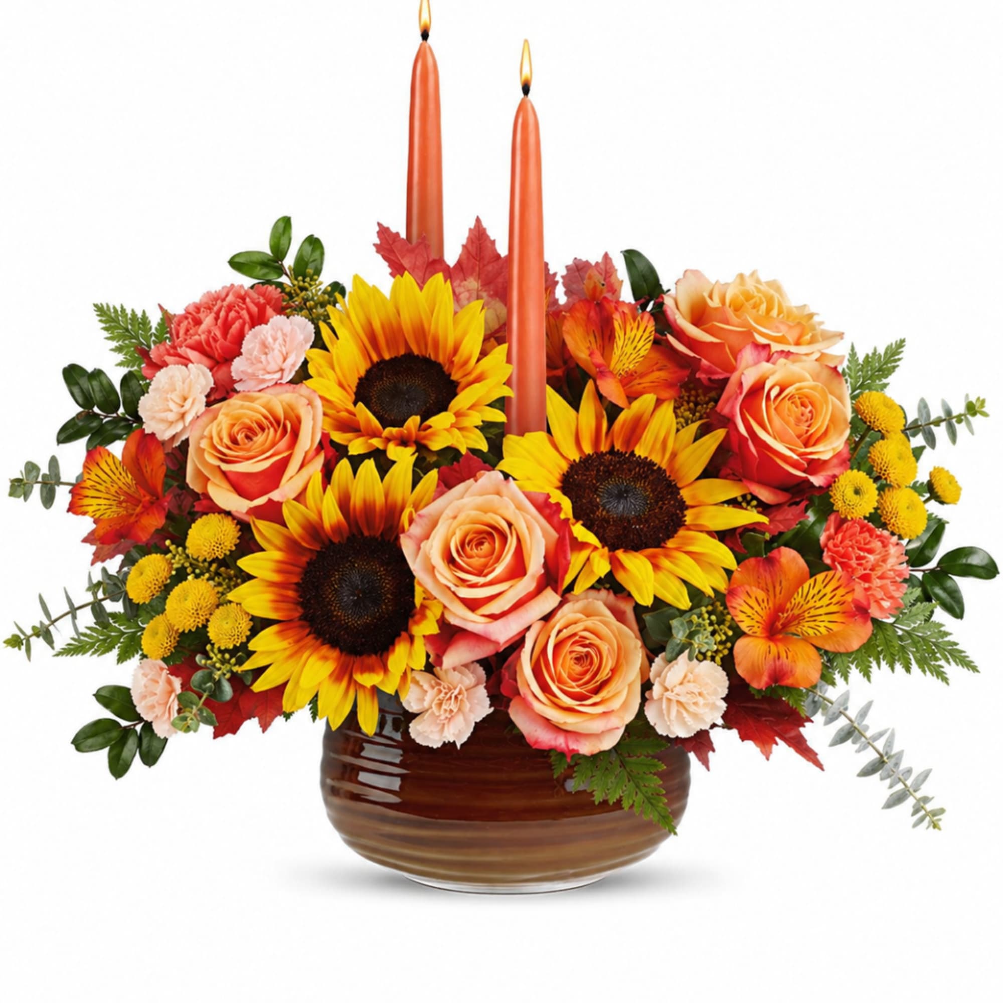 Sunflower and rose arrangement in a glass bowl with two orange candles