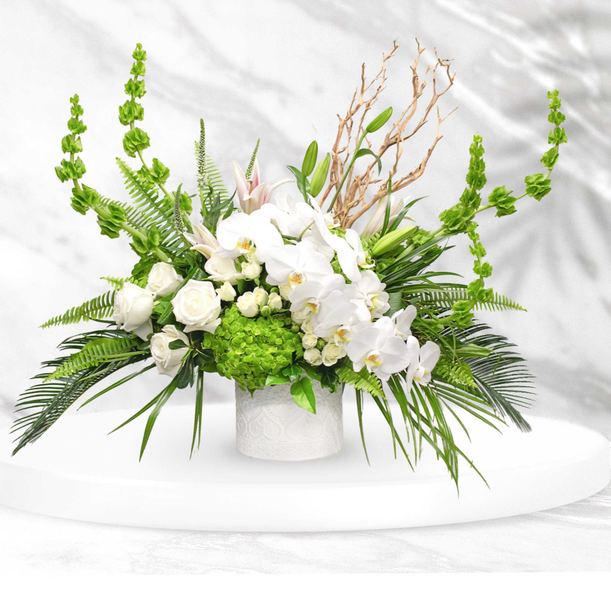 White orchids and roses in a white vase with bright green accents, photo 2 of 2